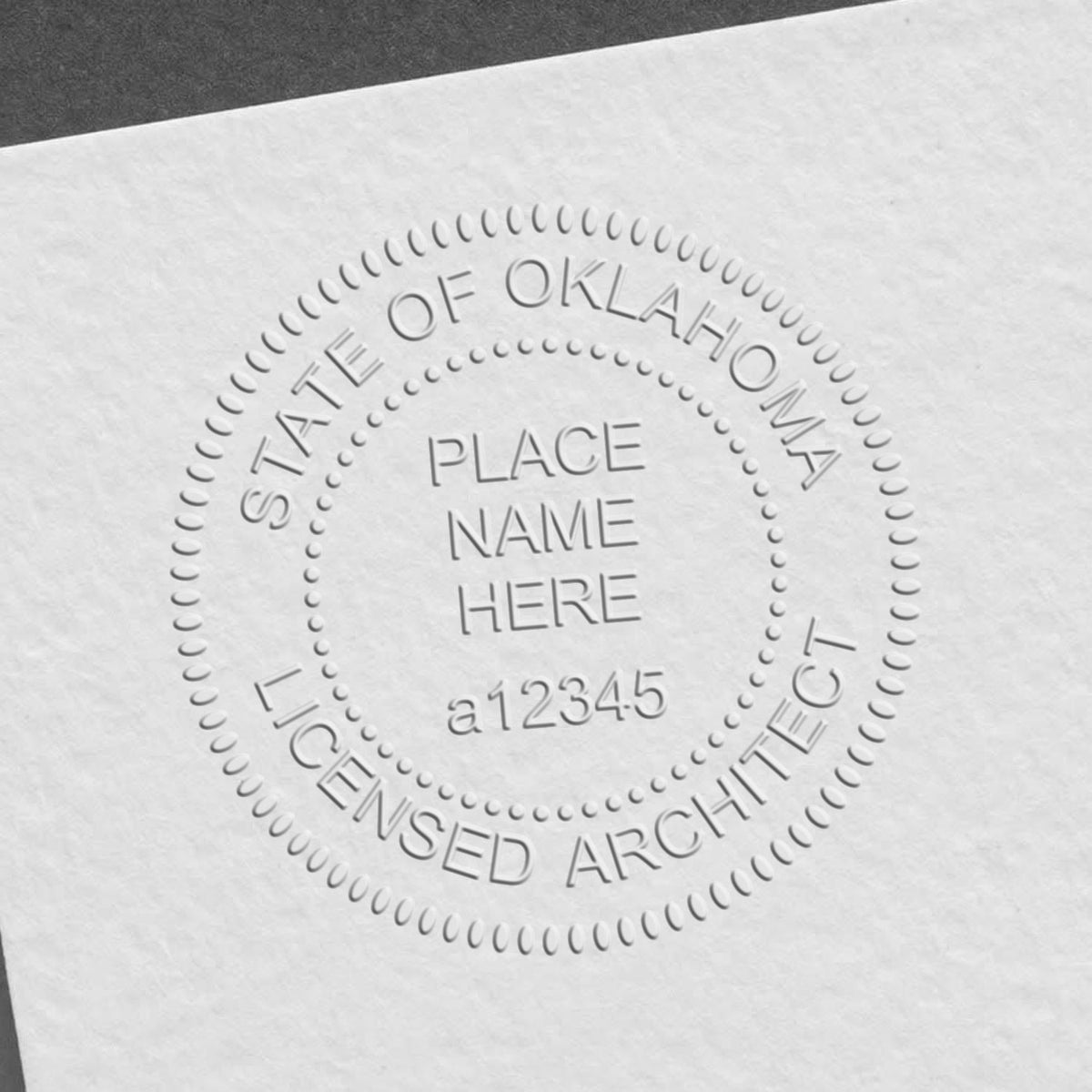 A stamped impression of the Handheld Oklahoma Architect Seal Embosser in this stylish lifestyle photo, setting the tone for a unique and personalized product.
