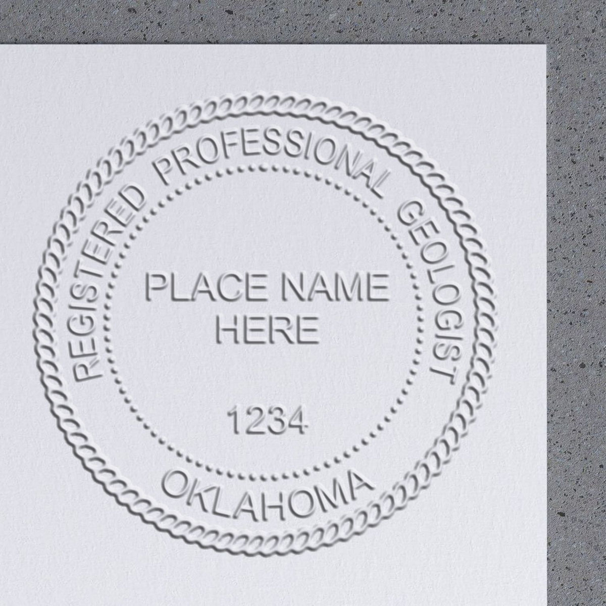 An in use photo of the State of Oklahoma Extended Long Reach Geologist Seal showing a sample imprint on a cardstock