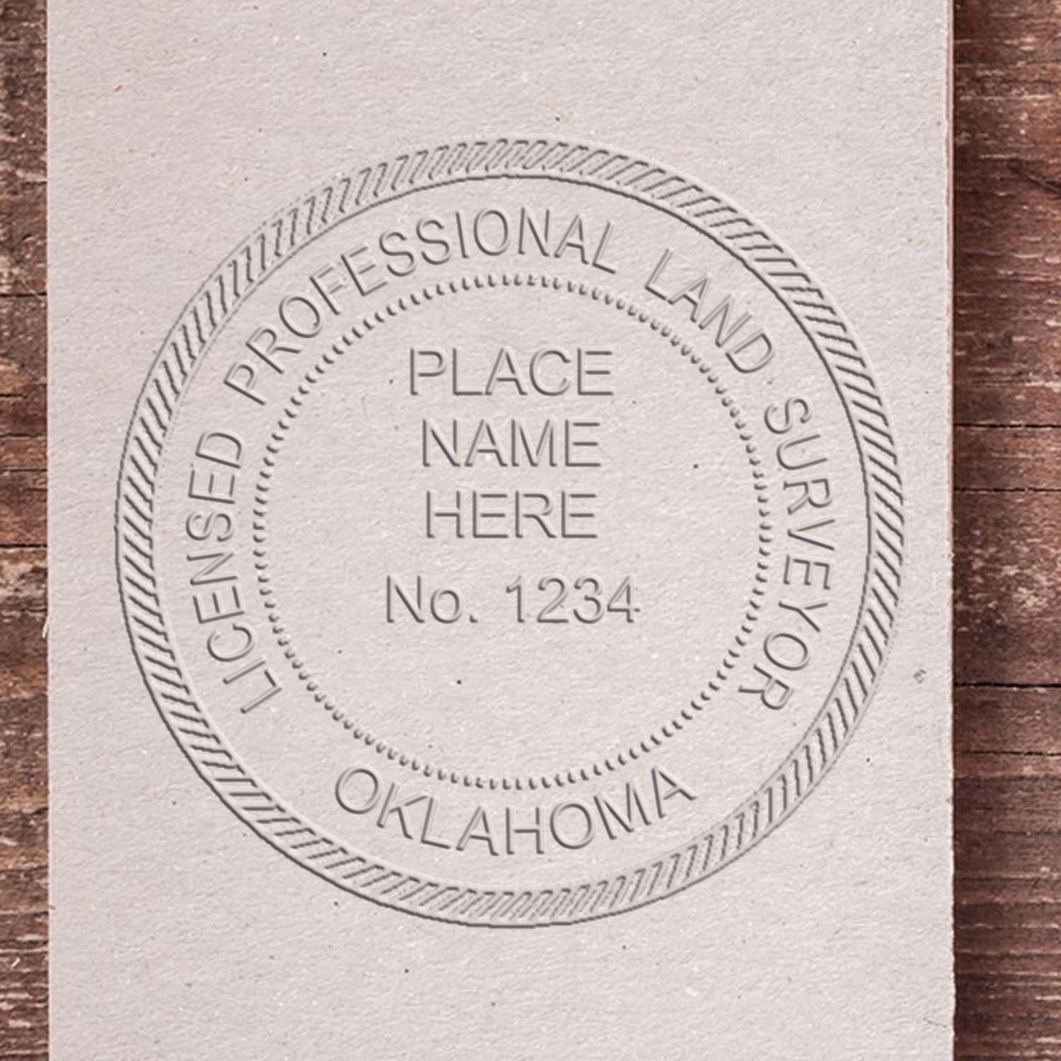 A lifestyle photo showing a stamped image of the Oklahoma Desk Surveyor Seal Embosser on a piece of paper