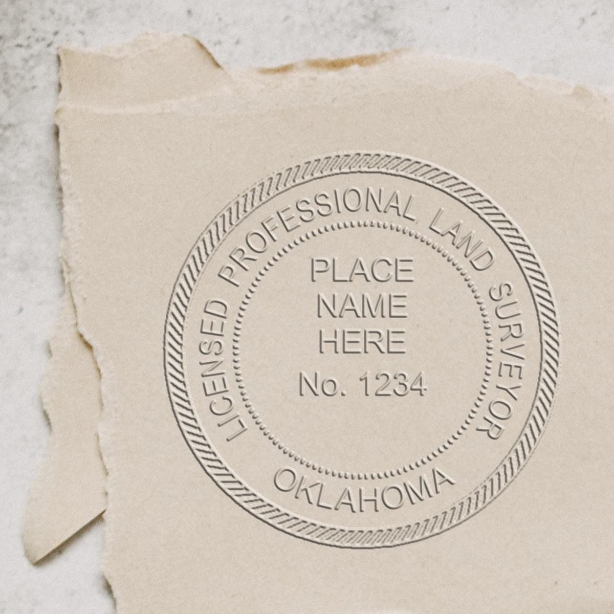 An in use photo of the Hybrid Oklahoma Land Surveyor Seal showing a sample imprint on a cardstock