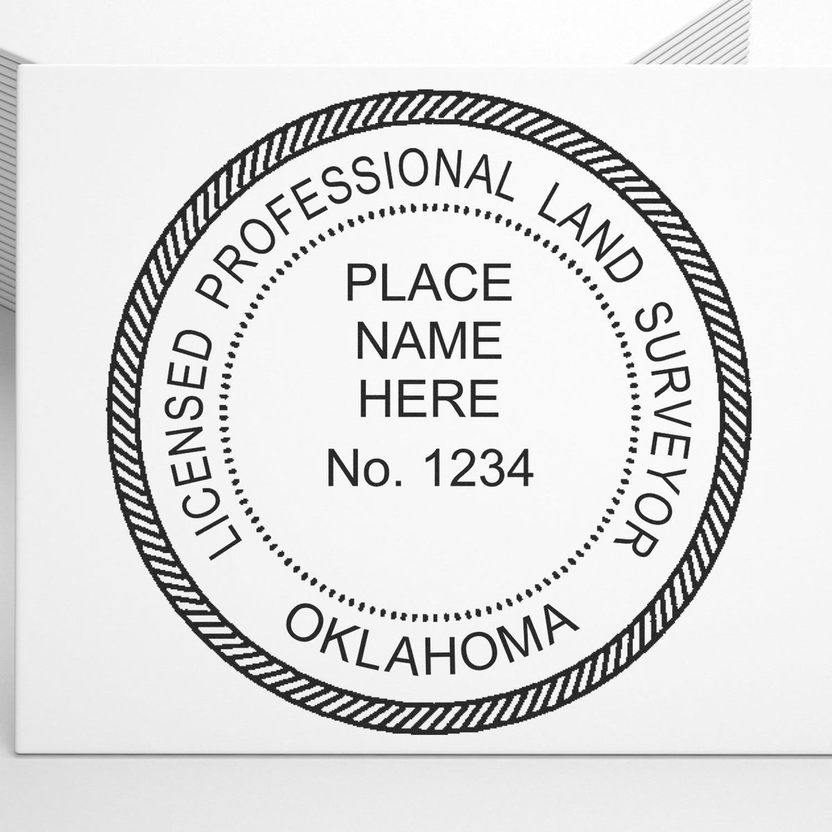 A lifestyle photo showing a stamped image of the Slim Pre-Inked Oklahoma Land Surveyor Seal Stamp on a piece of paper