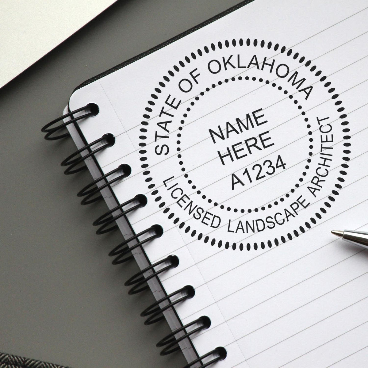 A lifestyle photo showing a stamped image of the Oklahoma Landscape Architectural Seal Stamp on a piece of paper