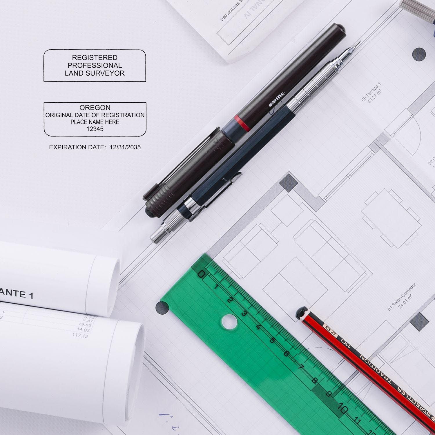 Premium MaxLight Pre-Inked Oregon Surveyors Stamp in use on architectural plans with pens, ruler, and rolled blueprints on a desk.
