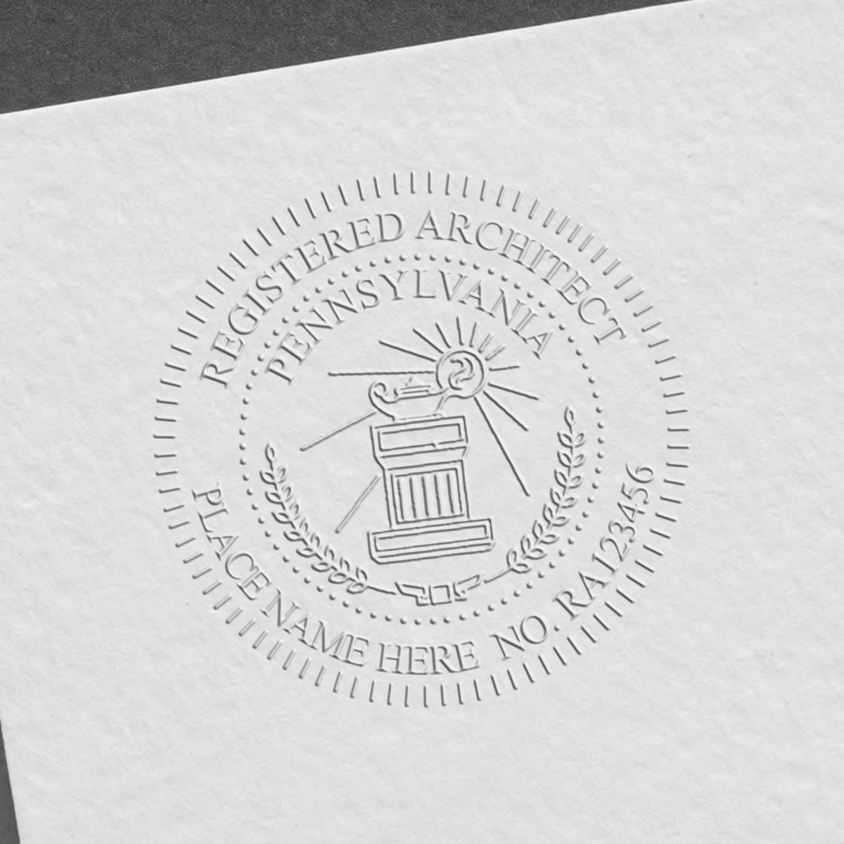 An in use photo of the Hybrid Pennsylvania Architect Seal showing a sample imprint on a cardstock