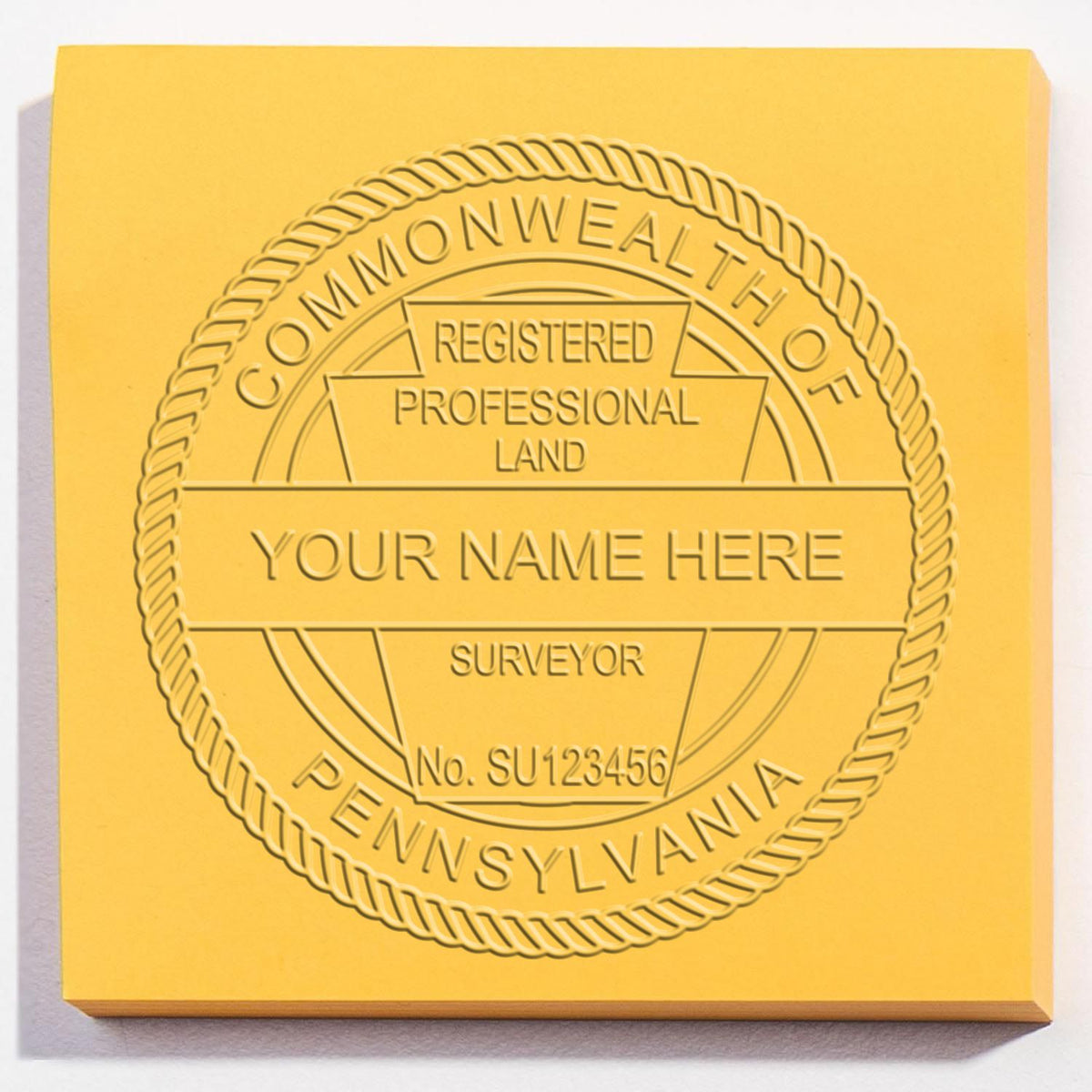 An in use photo of the Hybrid Pennsylvania Land Surveyor Seal showing a sample imprint on a cardstock