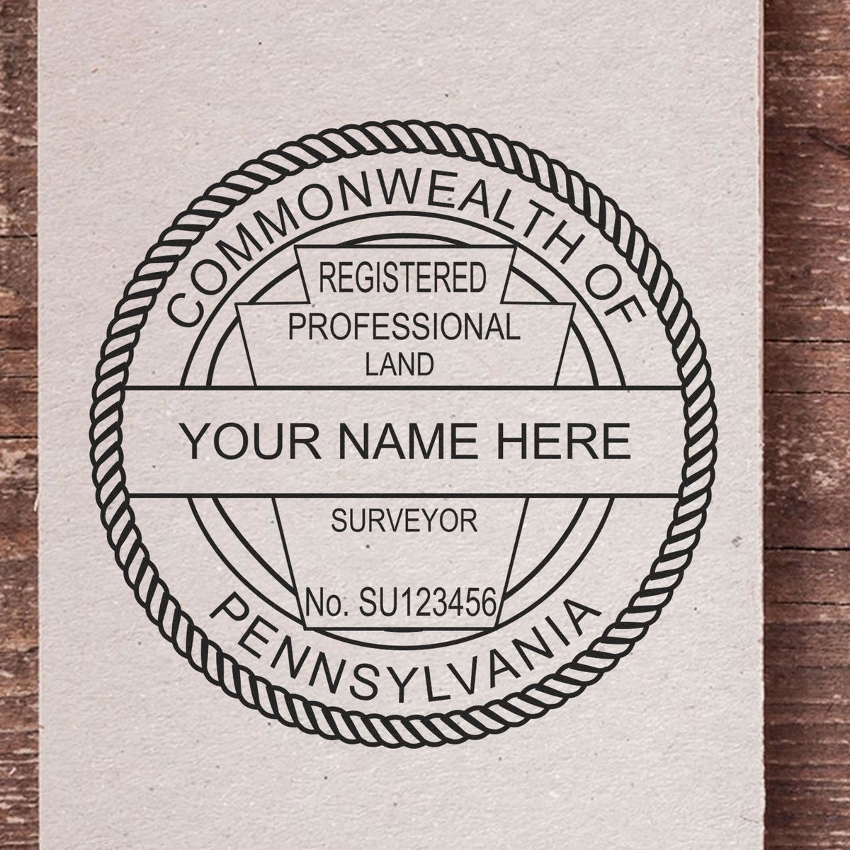 A lifestyle photo showing a stamped image of the Slim Pre-Inked Pennsylvania Land Surveyor Seal Stamp on a piece of paper