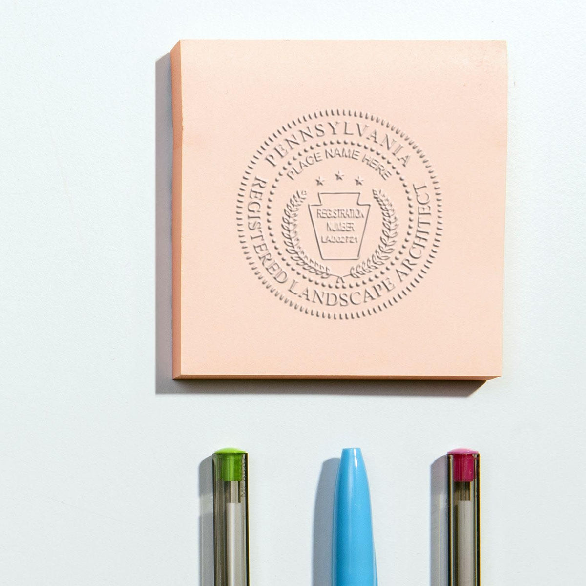 An in use photo of the Gift Pennsylvania Landscape Architect Seal showing a sample imprint on a cardstock