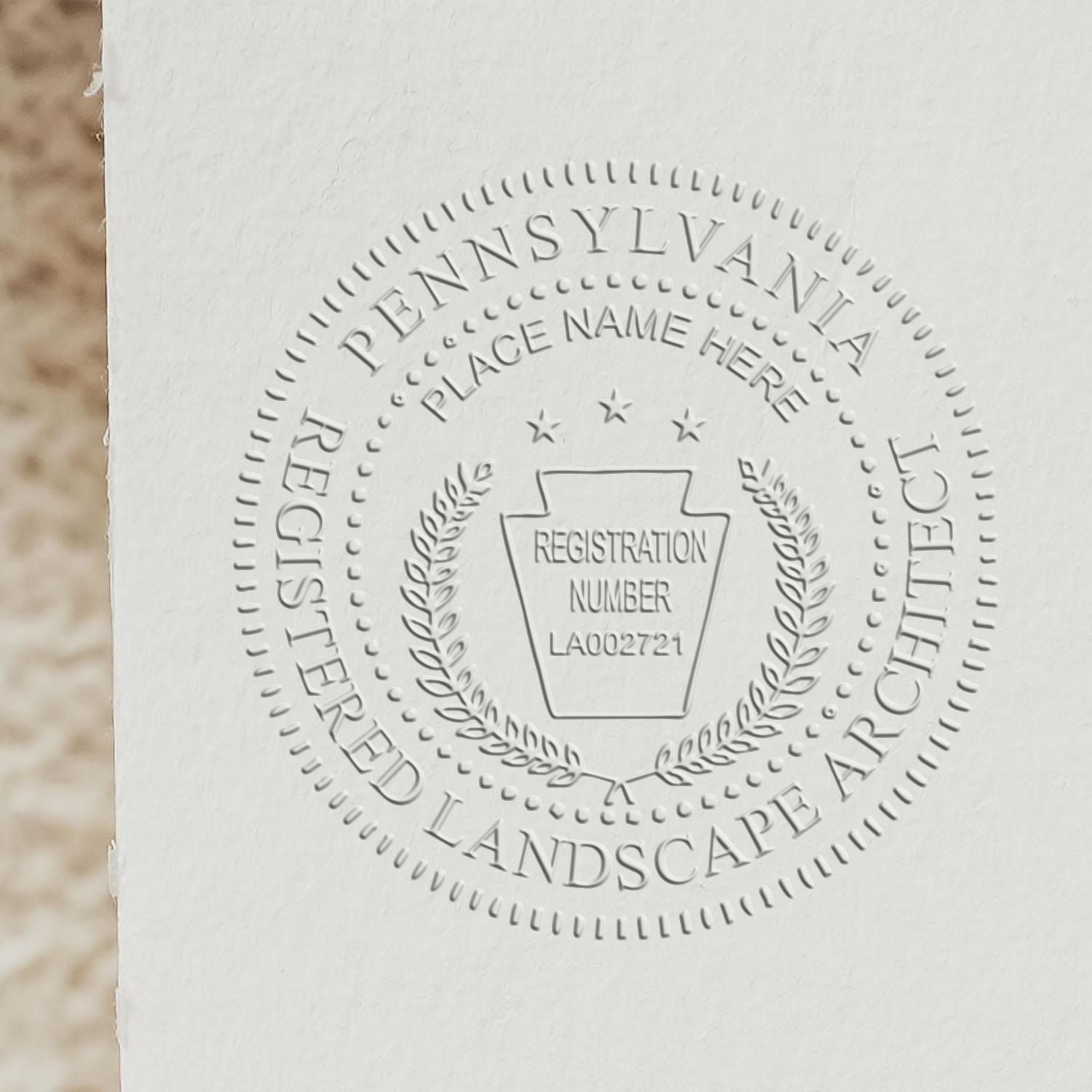 A stamped impression of the State of Pennsylvania Handheld Landscape Architect Seal in this stylish lifestyle photo, setting the tone for a unique and personalized product.