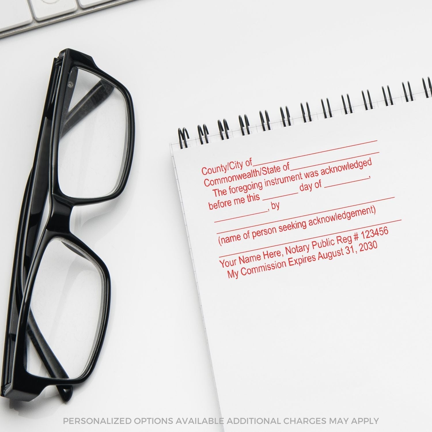 Self Inking Acknowledgment Stamp in use on a notepad beside black-framed glasses, showing a notary acknowledgment template in red ink.