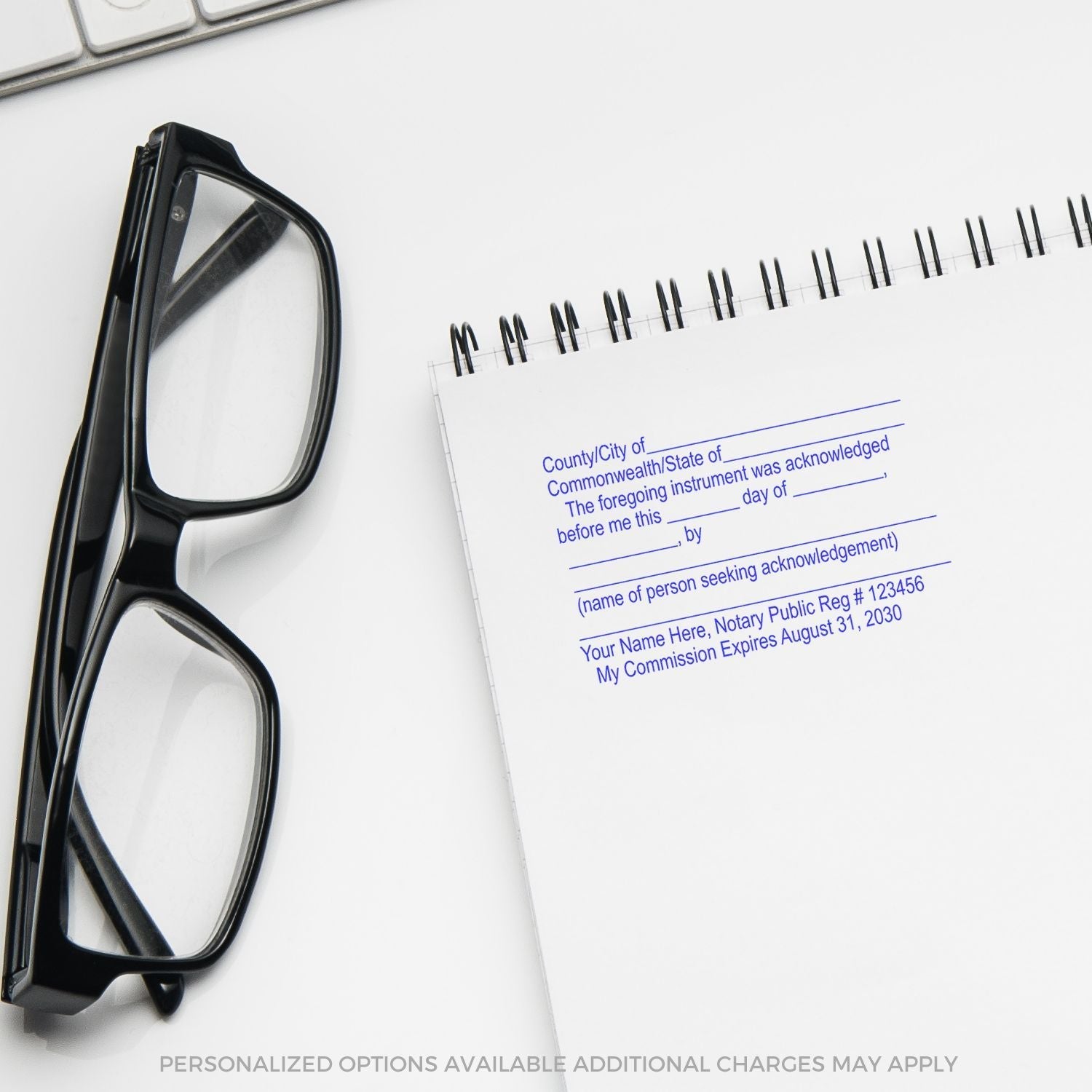 A Self Inking Notary Certified Copy Stamp imprint on a white notepad next to black eyeglasses, with customizable text fields.