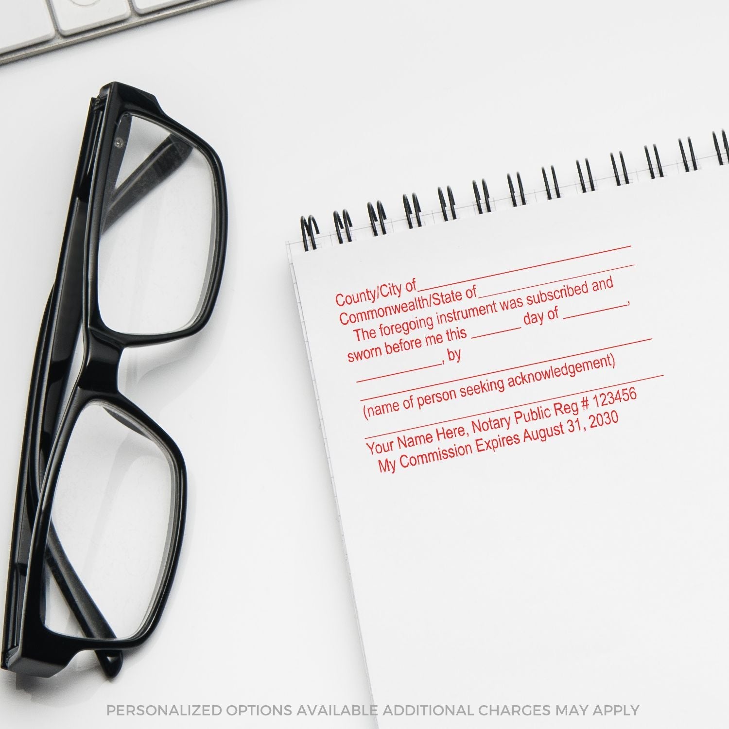 A Jurat Notary Stamp imprint on a notepad next to black eyeglasses, showing customizable fields for notary details and commission expiration.