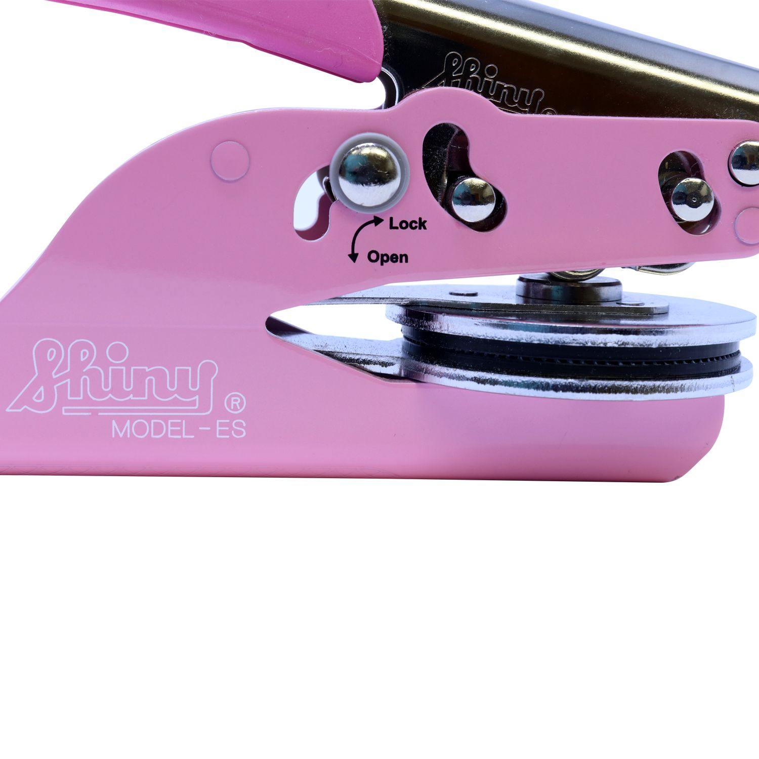 Close-up of the Interior Designer Pink Soft Seal Embosser in locked position, showing the shiny metal parts and the lock/open mechanism.