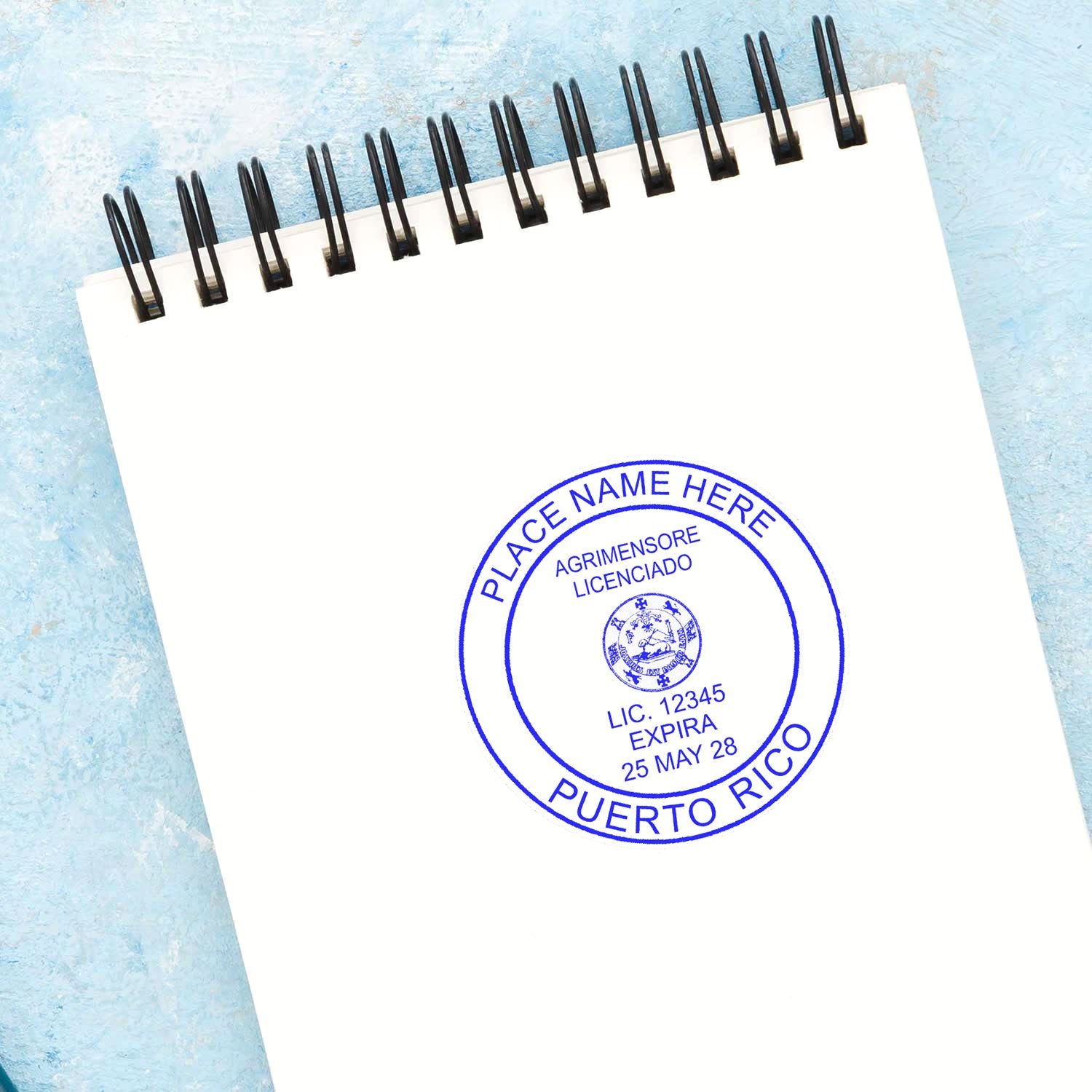 Premium MaxLight Pre-Inked Puerto Rico Surveyors Stamp on a white notepad, displaying a blue circular seal with customizable text.