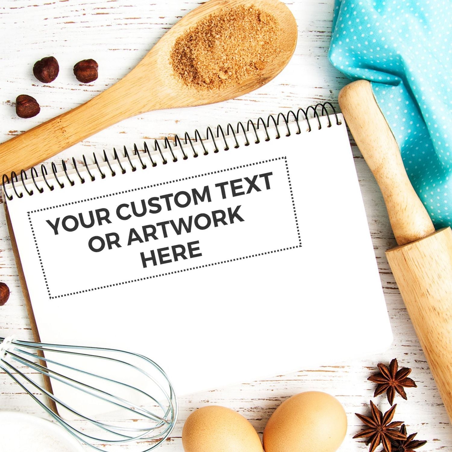 Custom Rubber Stamp Size 3 x 9 stamped on a notepad surrounded by baking items like a wooden spoon, rolling pin, eggs, and spices.