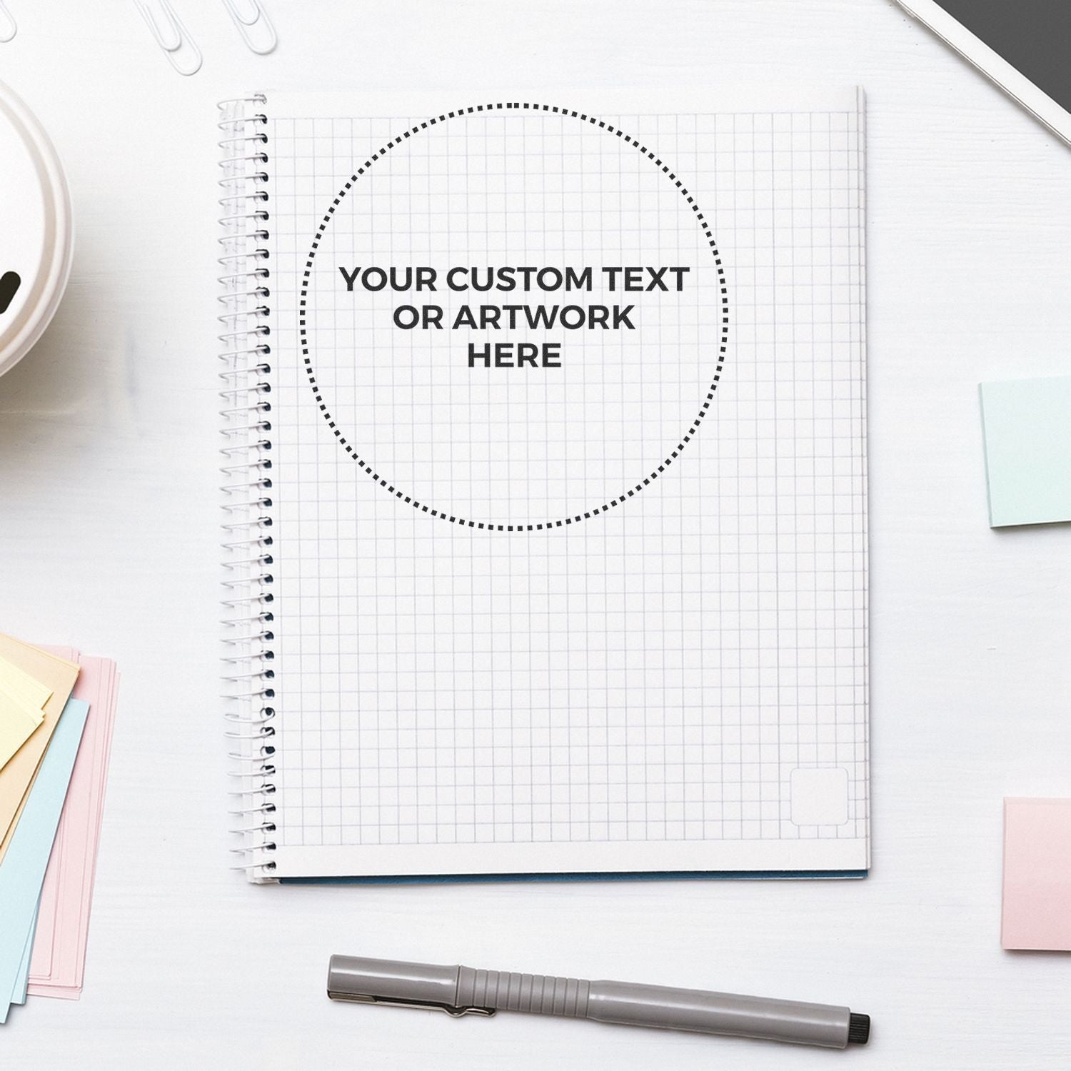 Notebook with a stamped circle reading YOUR CUSTOM TEXT OR ARTWORK HERE using the Custom Rubber Stamp Size 6 Inch Diameter, pen nearby.