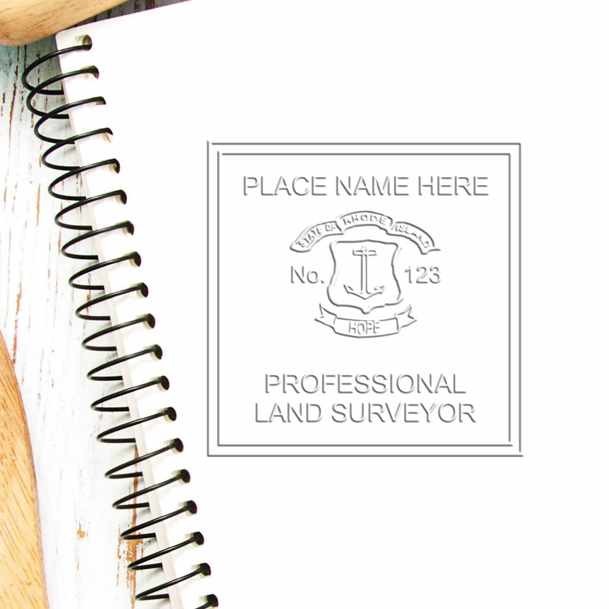 An in use photo of the Hybrid Rhode Island Land Surveyor Seal showing a sample imprint on a cardstock