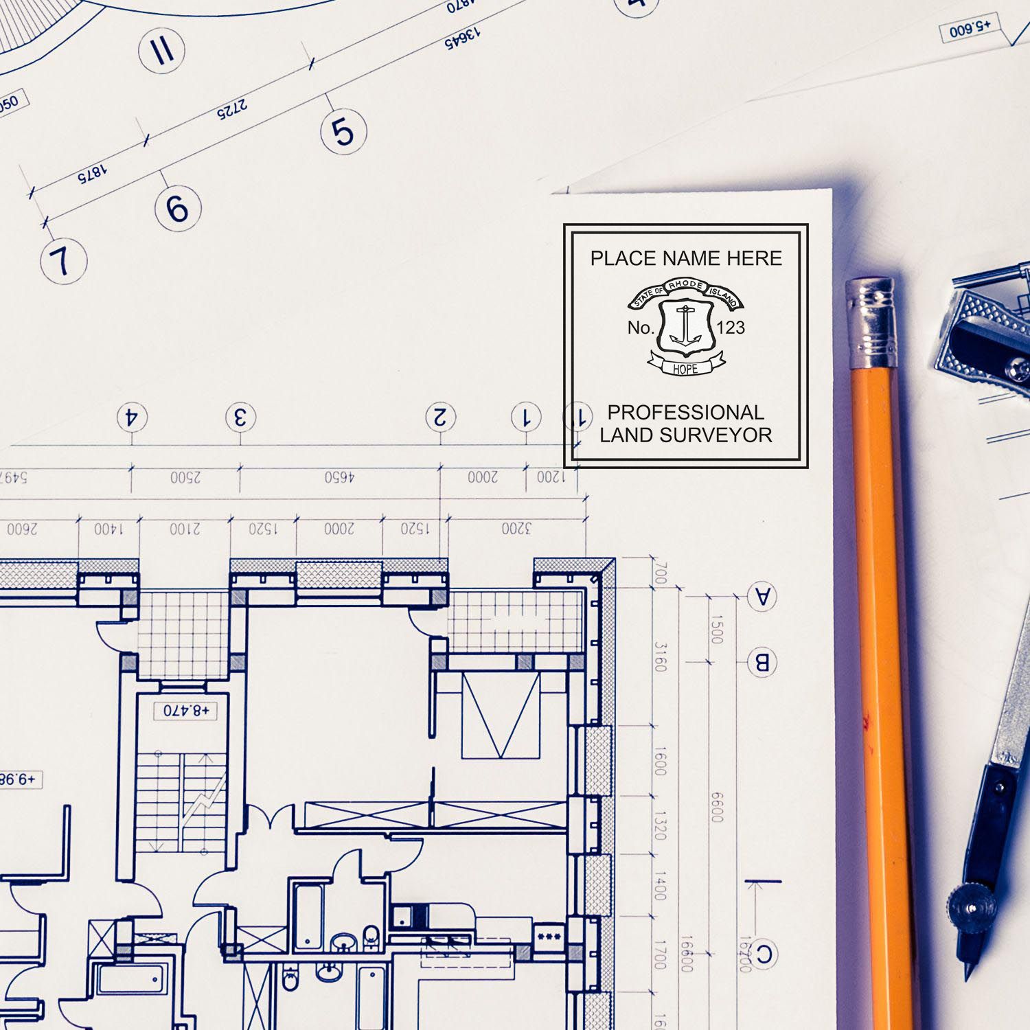 Premium MaxLight Pre-Inked Rhode Island Surveyors Stamp on architectural blueprints with pencil and drafting tools.