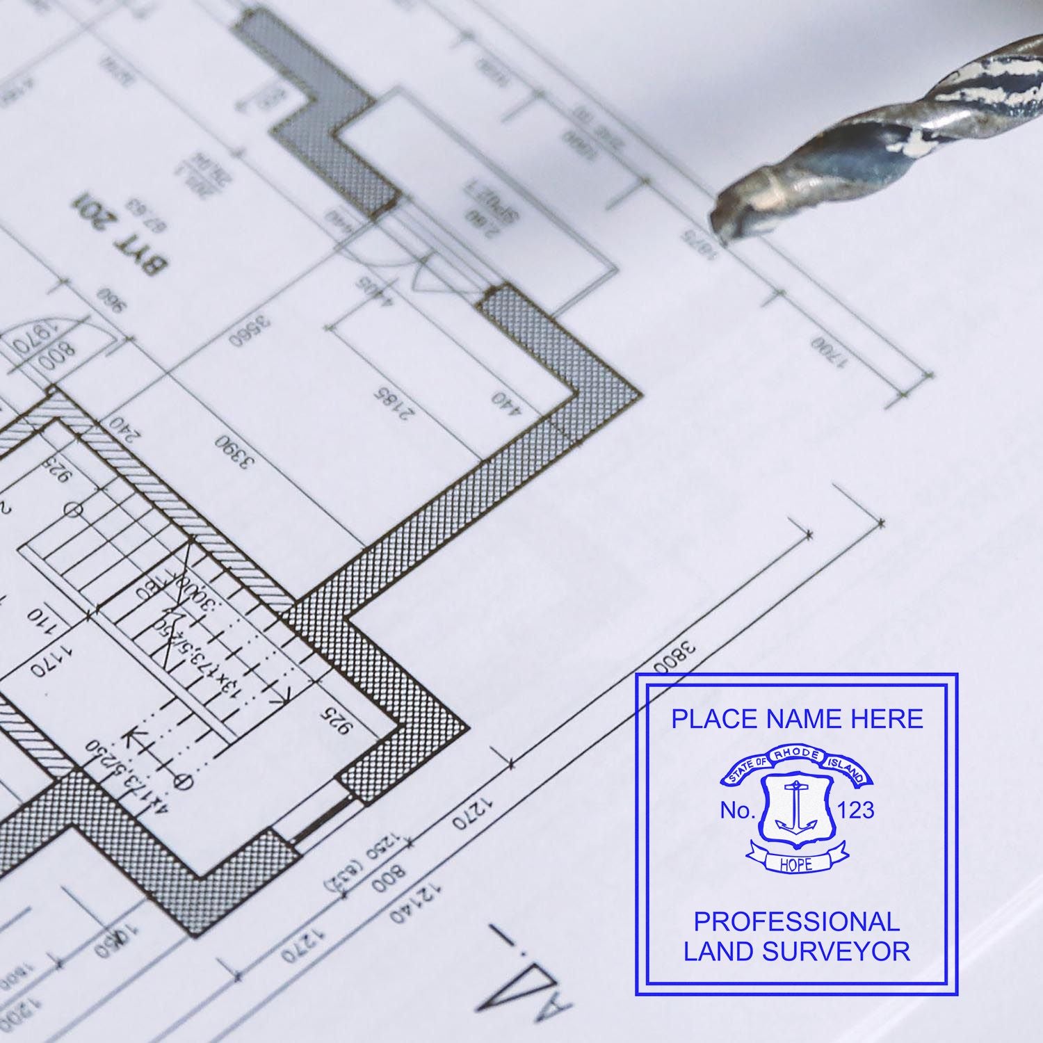 Digital Rhode Island Land Surveyor Stamp, Electronic Seal for Rhode Island Land Surveyor on a blueprint with a drill bit nearby.