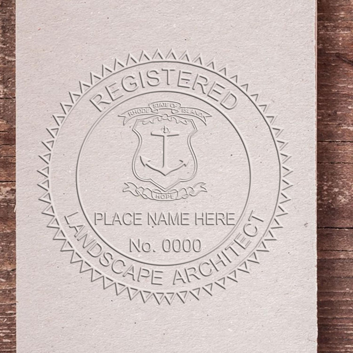 An in use photo of the Hybrid Rhode Island Landscape Architect Seal showing a sample imprint on a cardstock