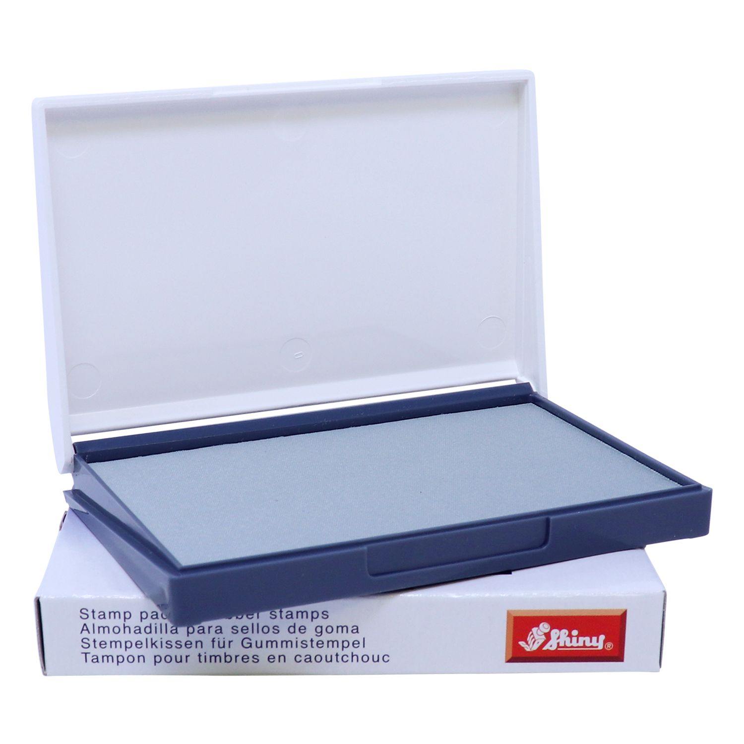 Rubber Stamp Ink Pad 1 Size 2-3/4 x 4-1/4, open with a gray pad inside, placed on a white box with product details.