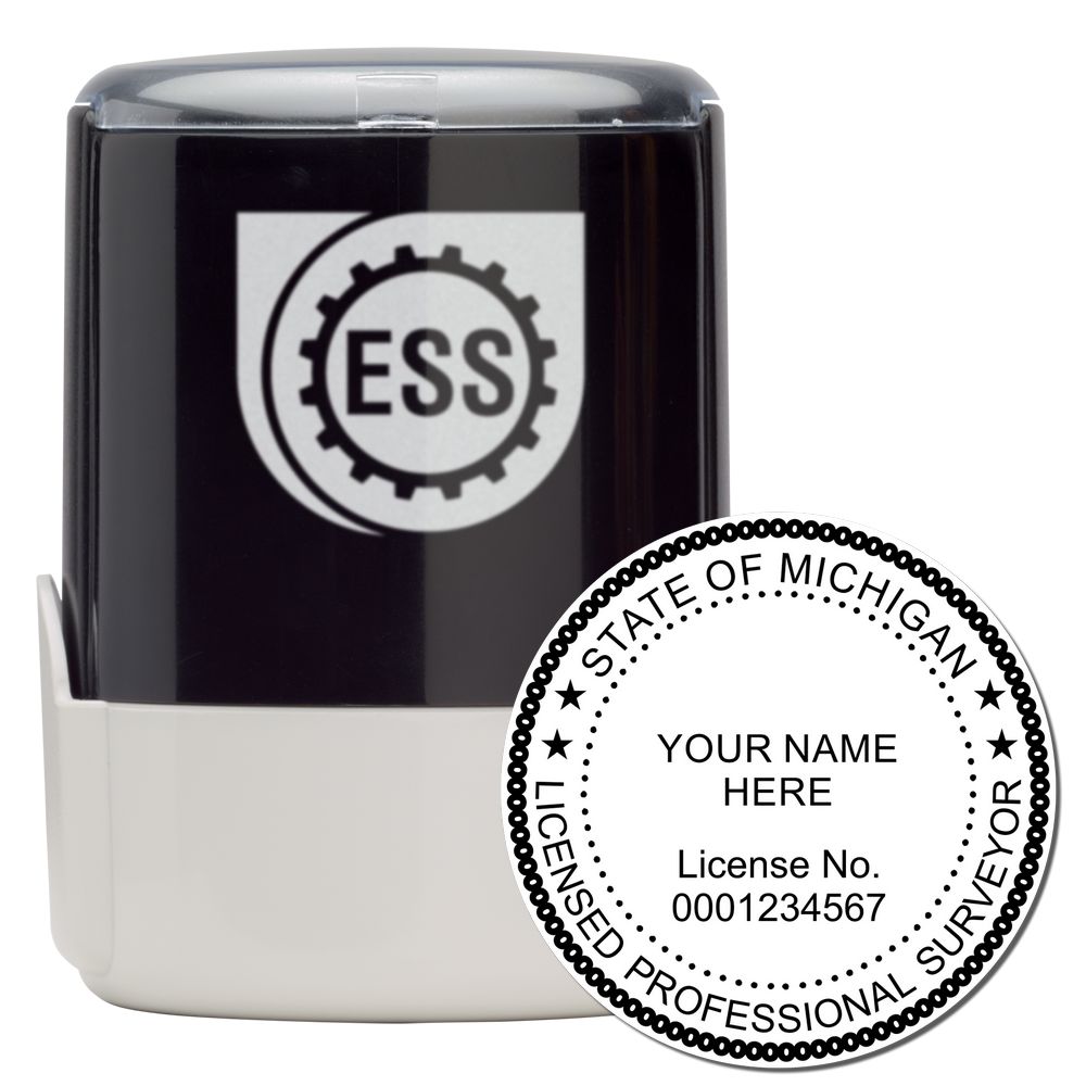 Self Inking Michigan Land Surveyor Stamp with a black and white design, featuring a protective cover and a sample imprint showing license details.