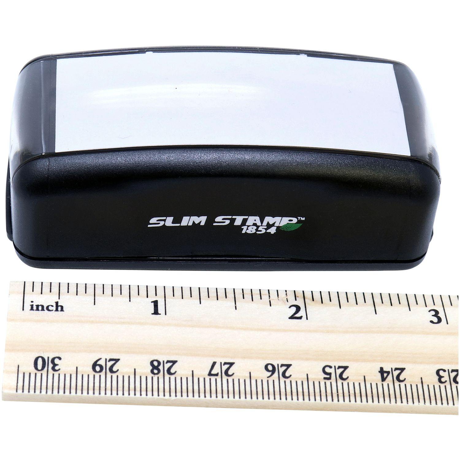 Large Pre-Inked Special Handling Stamp, black with white label, next to a ruler showing its compact size.