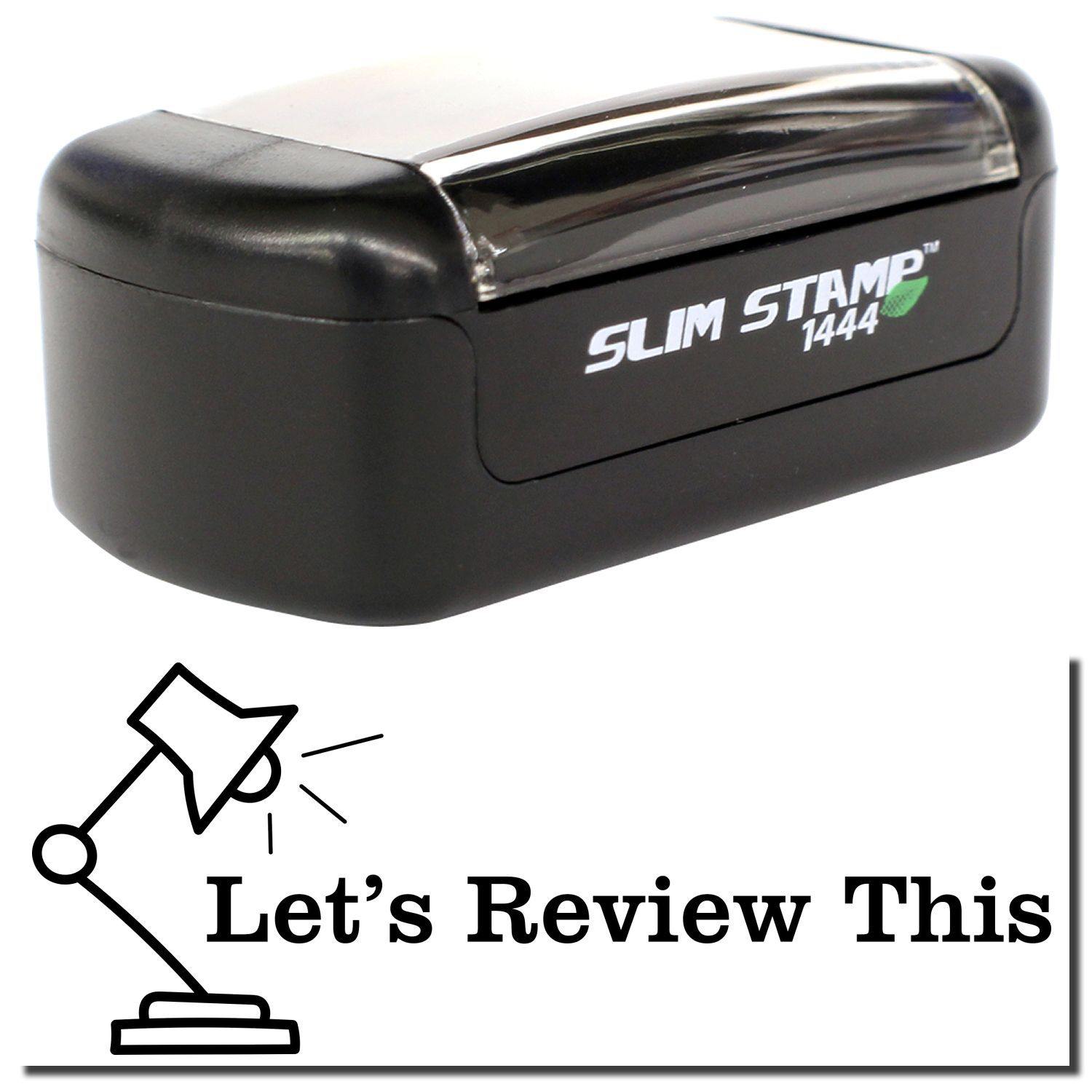 A stock office pre-inked stamp with a stamped image showing how the text "LET'S REVIEW THIS" with a lamp image on the left side is displayed after stamping.