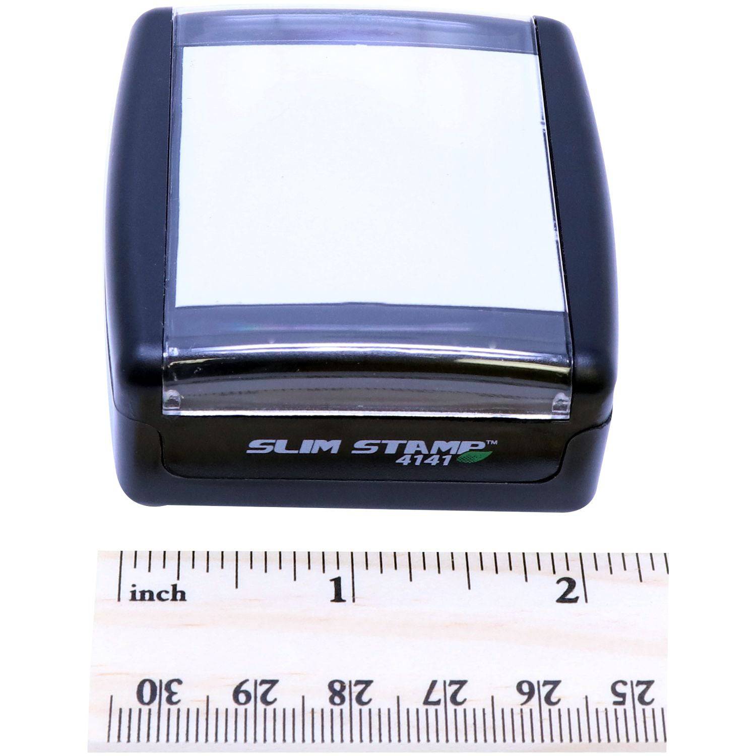 Professional Engineer Slim Pre-Inked Stamp of Seal with a black casing and a clear top, placed next to a wooden ruler showing inches for size reference.