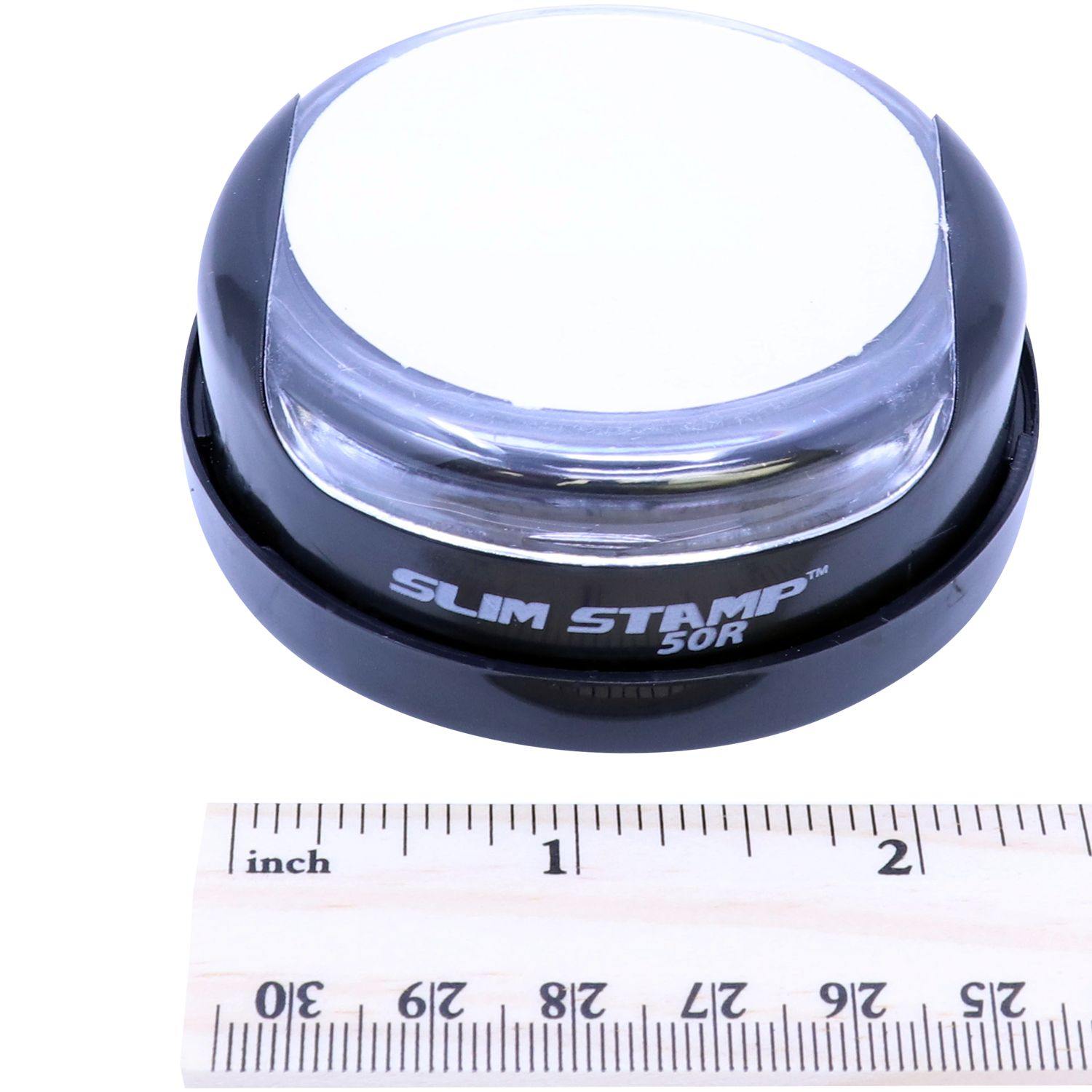 Interior Designer Slim Pre Inked Rubber Stamp of Seal, round black stamp with clear top, next to a ruler showing its compact size.