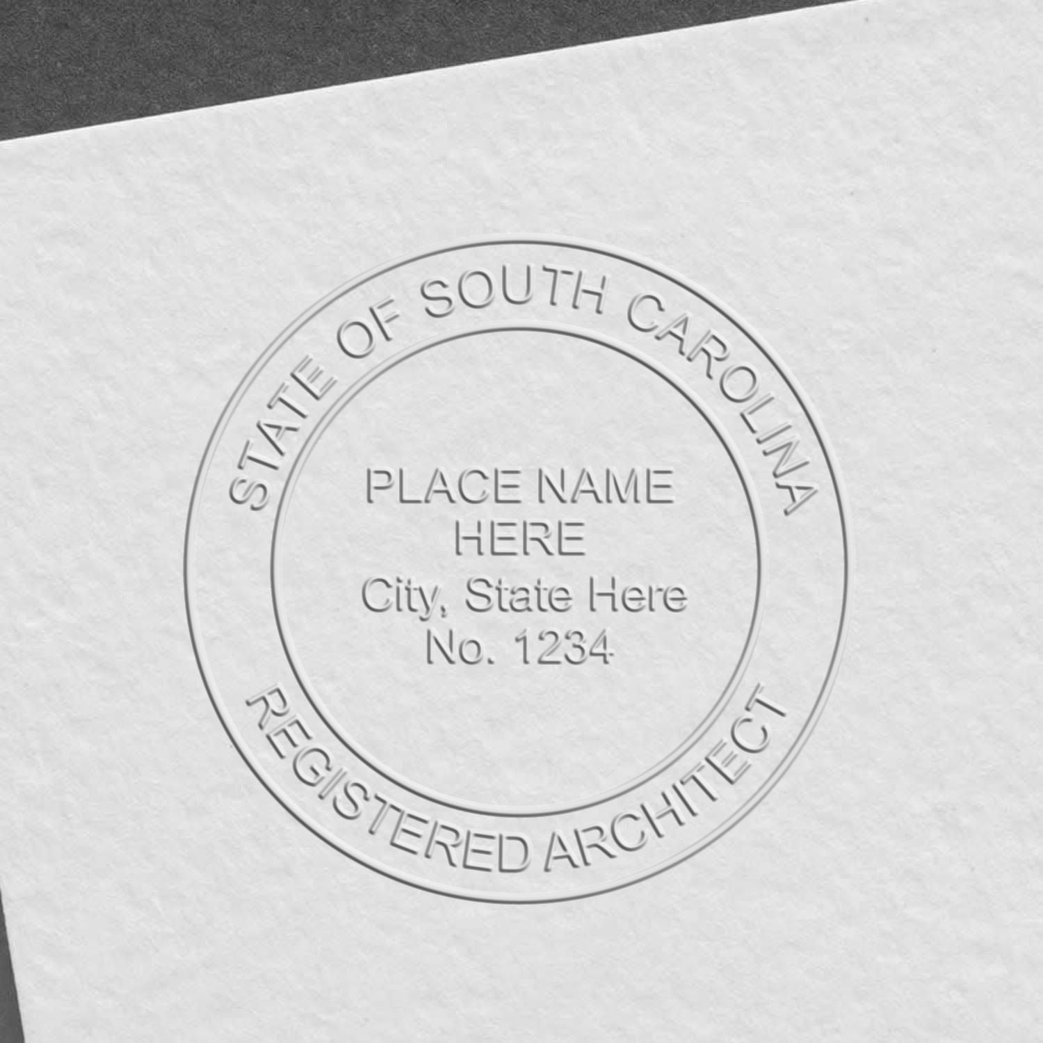 A lifestyle photo showing a stamped image of the Handheld South Carolina Architect Seal Embosser on a piece of paper