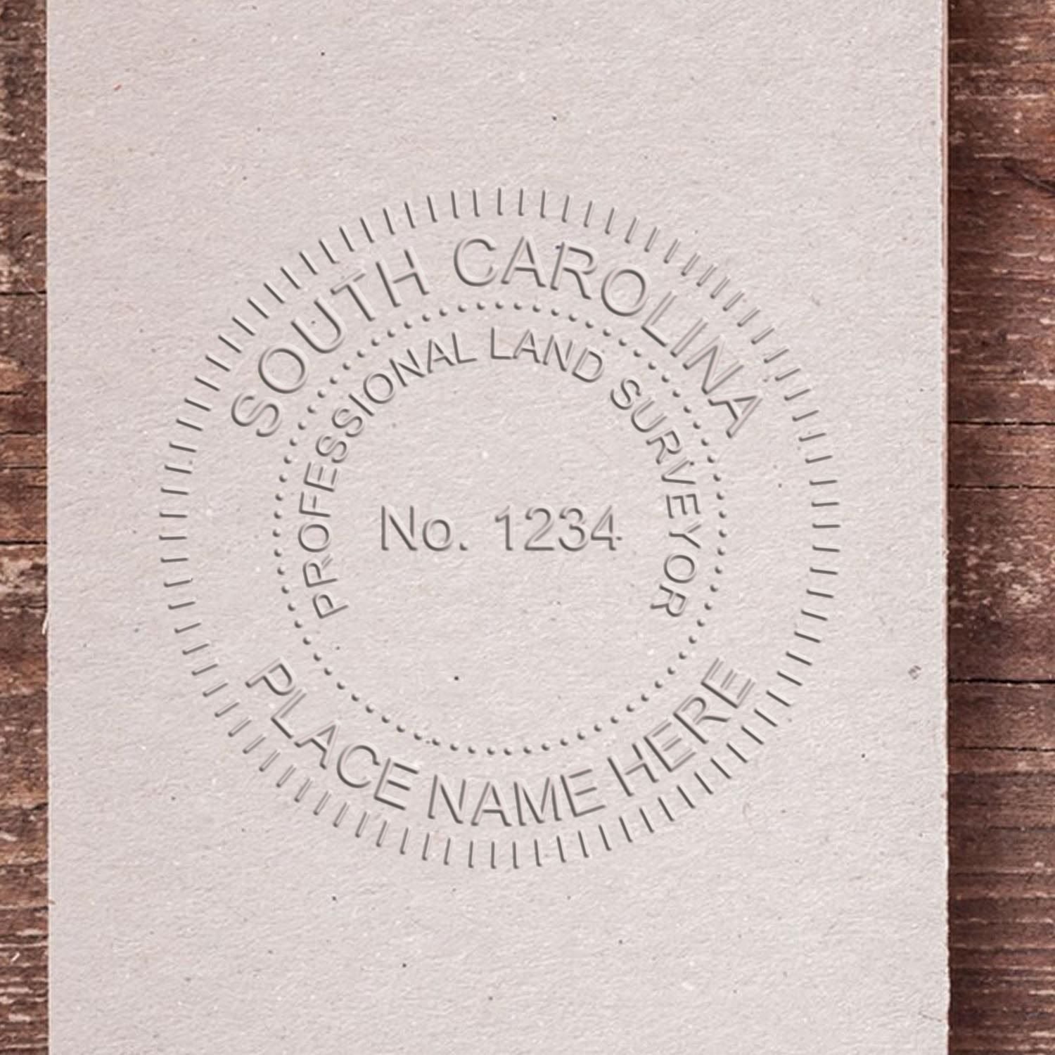 A stamped impression of the Handheld South Carolina Land Surveyor Seal in this stylish lifestyle photo, setting the tone for a unique and personalized product.