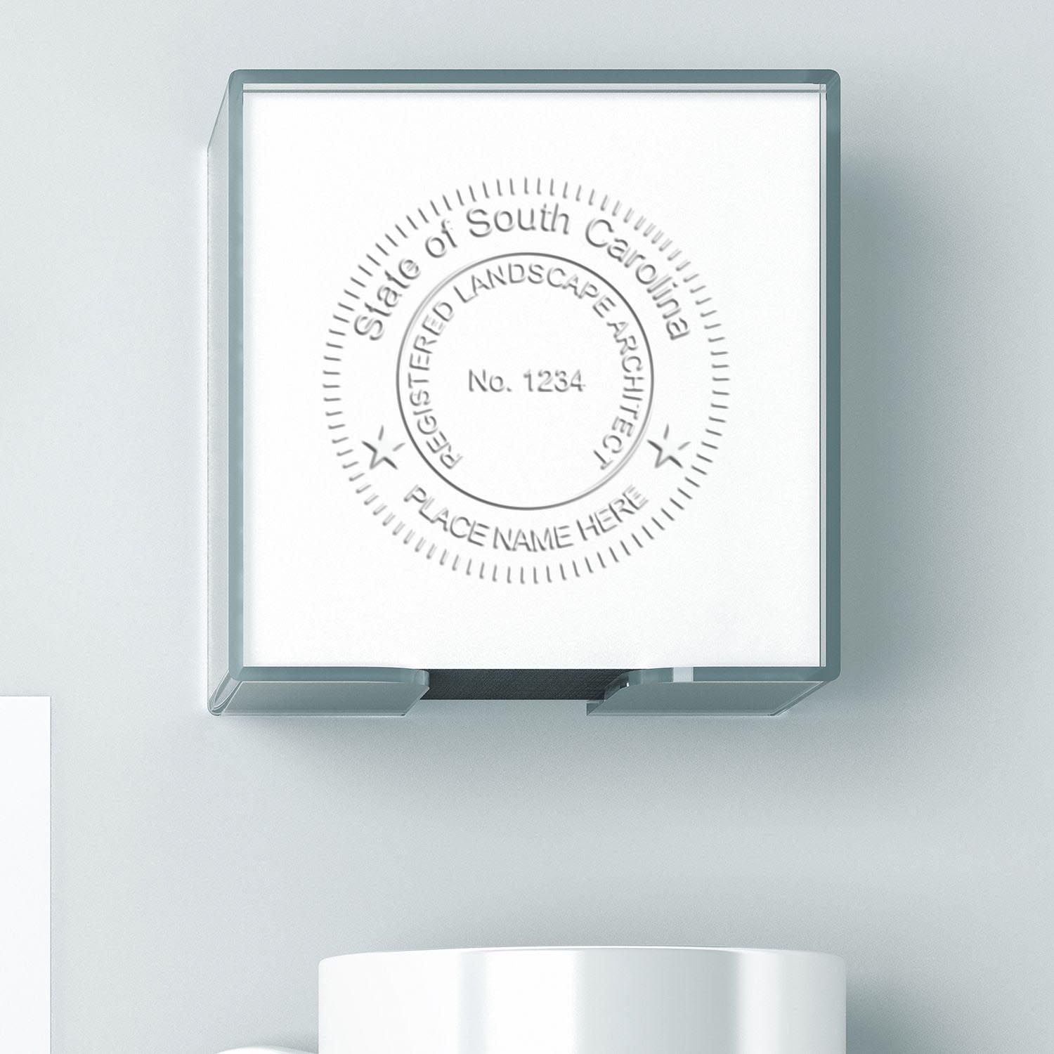 A lifestyle photo showing a stamped image of the State of South Carolina Extended Long Reach Landscape Architect Seal Embosser on a piece of paper