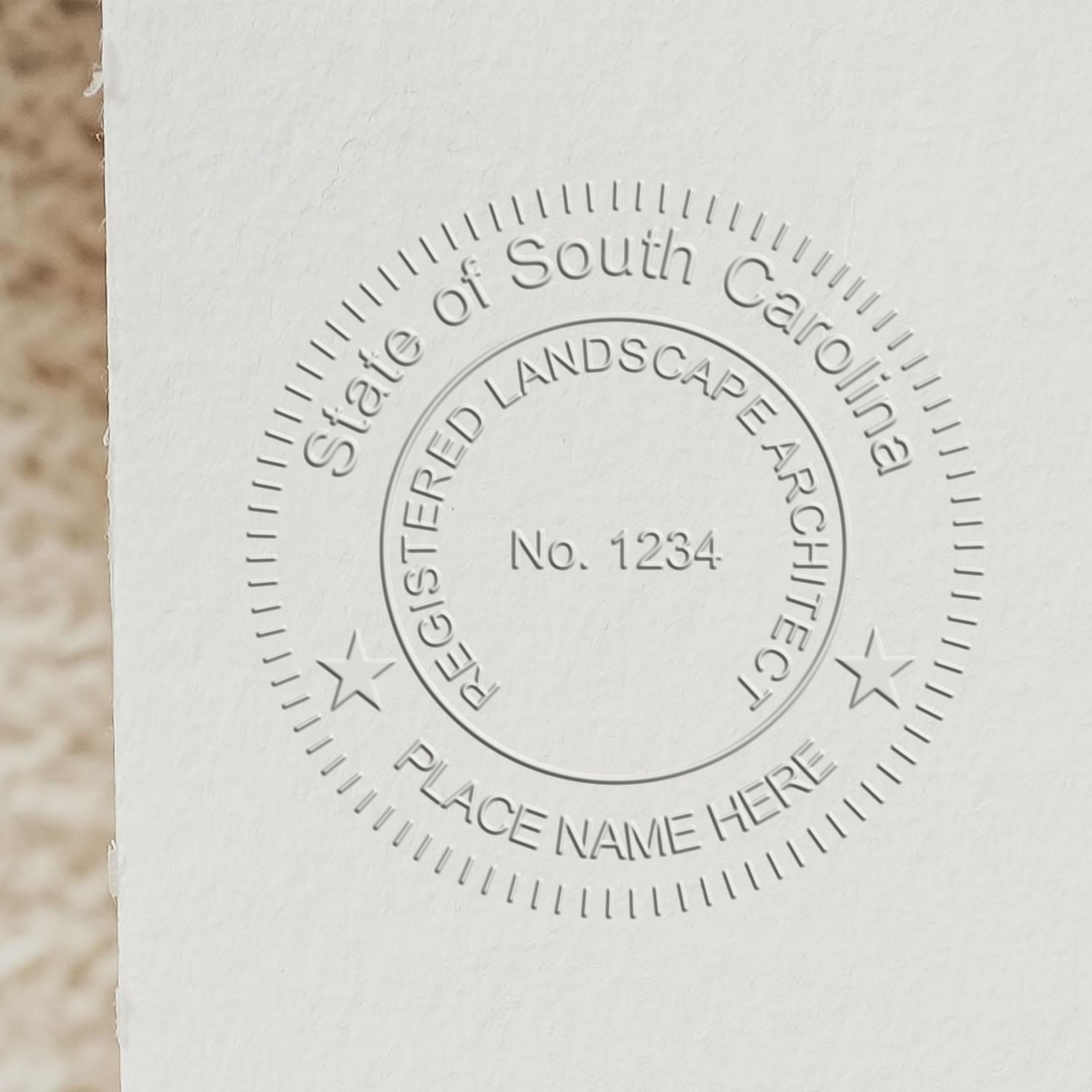 A stamped impression of the South Carolina Desk Landscape Architectural Seal Embosser in this stylish lifestyle photo, setting the tone for a unique and personalized product.