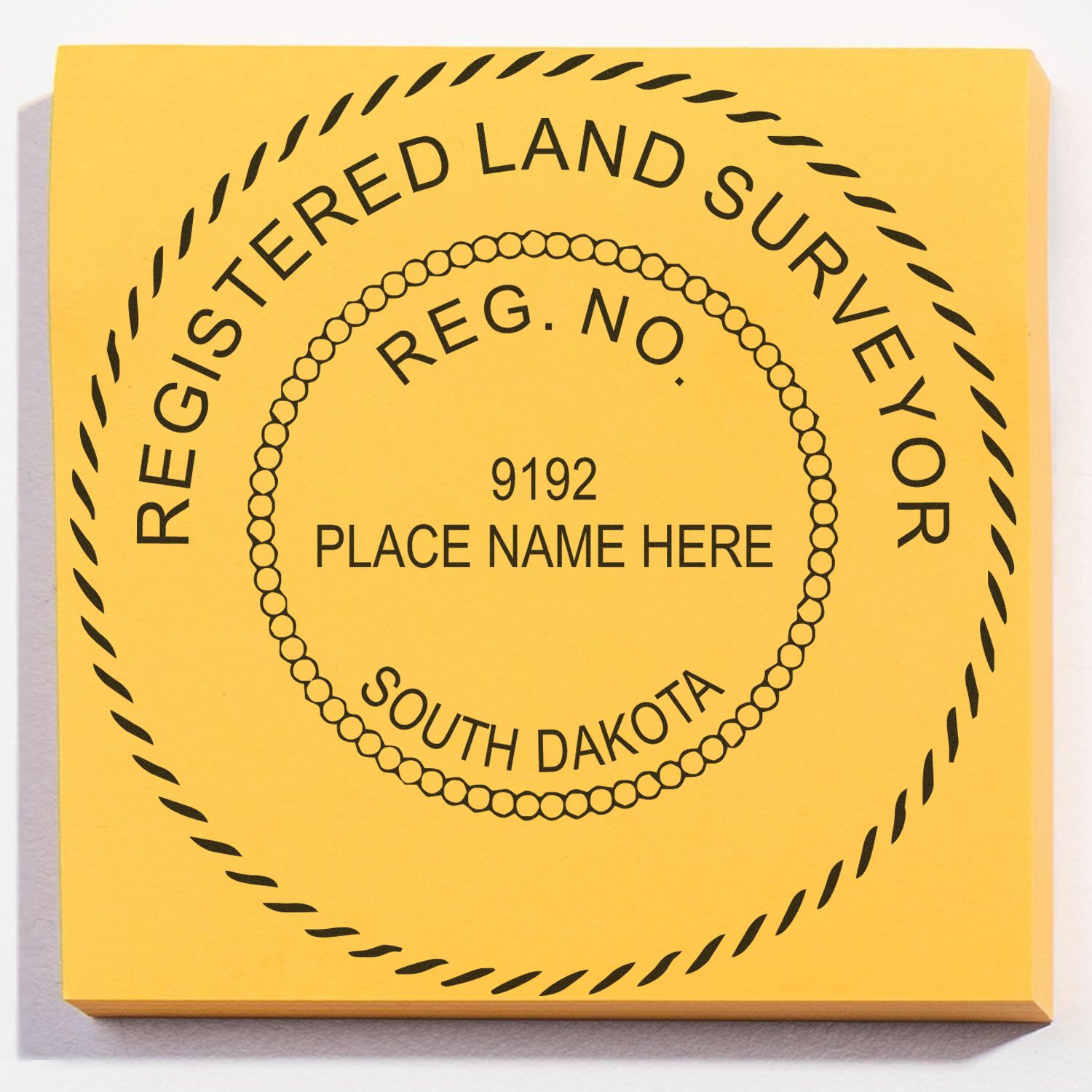 A lifestyle photo showing a stamped image of the Slim Pre-Inked South Dakota Land Surveyor Seal Stamp on a piece of paper