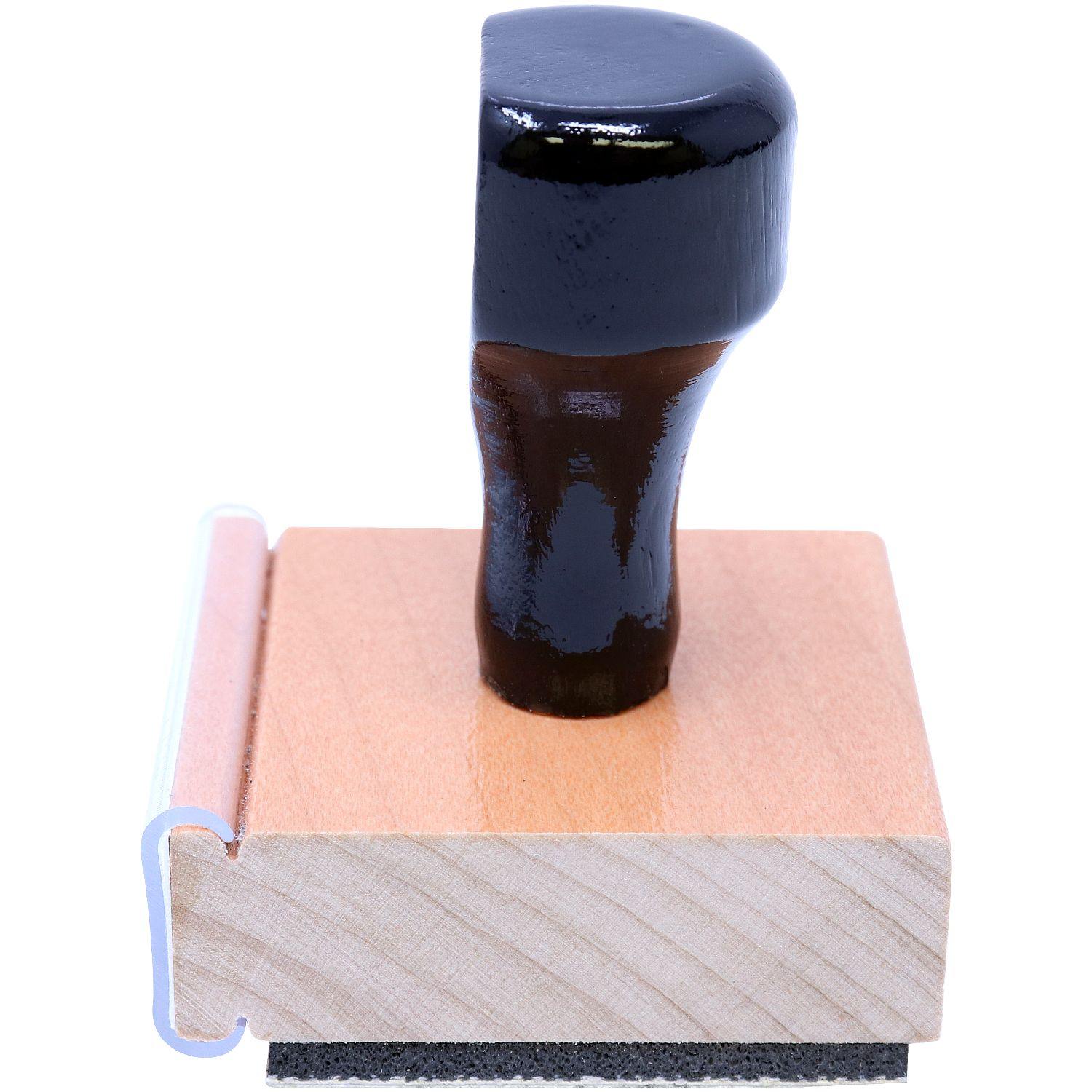 Land Surveyor Regular Rubber Stamp of Seal with a black handle and wooden base, side view showing the stamp's rubber bottom.