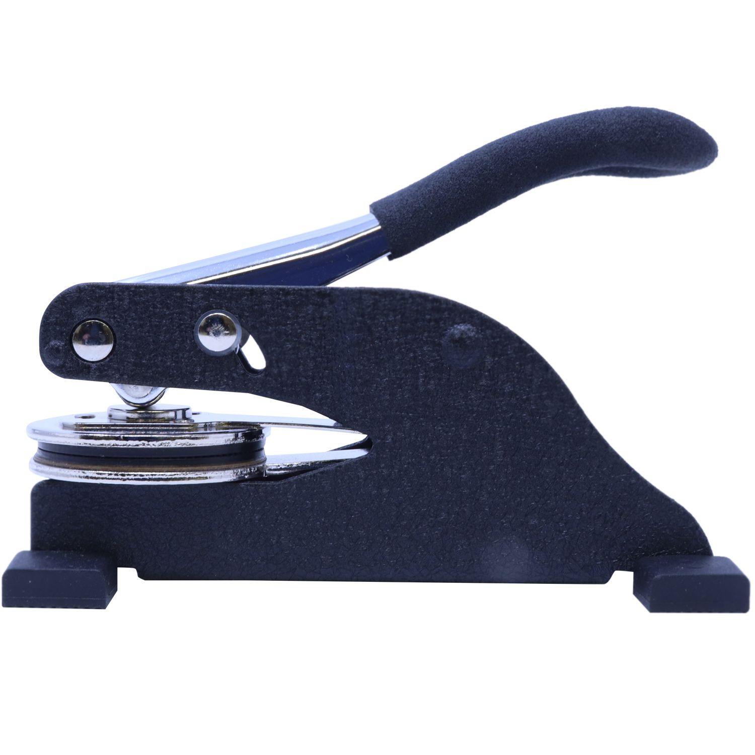 Forester Desk Seal Embosser with a black handle and metal components, designed for creating embossed imprints on documents.