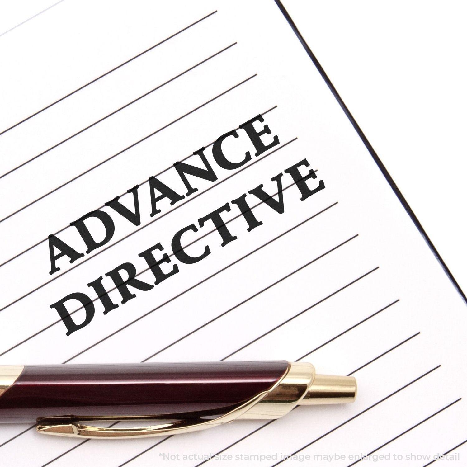 Large Advance Directive Rubber Stamp imprint on a lined paper with a pen placed diagonally across the bottom right corner.