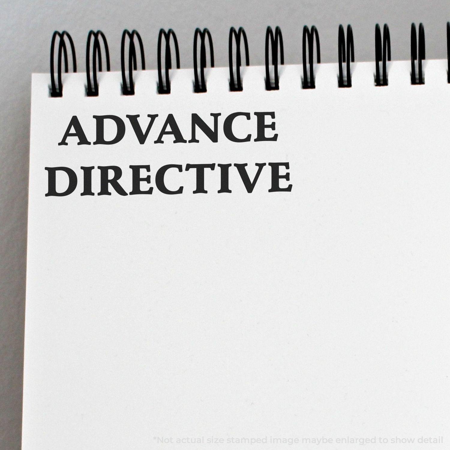 Large Self Inking Advance Directive Stamp imprint on a white notepad with spiral binding, showing clear and bold text.