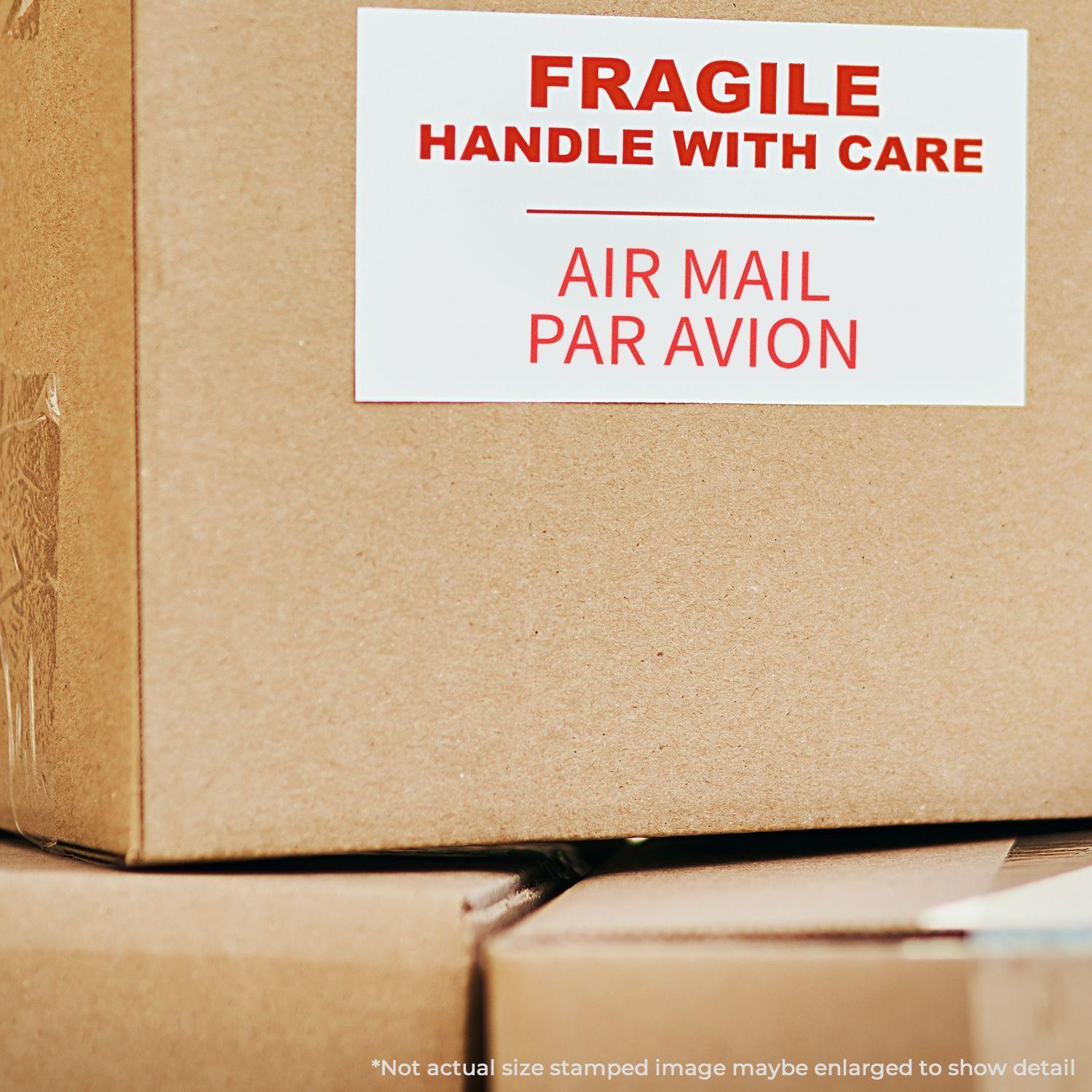 Cardboard box with a label reading FRAGILE HANDLE WITH CARE and AIR MAIL PAR AVION stamped in red.