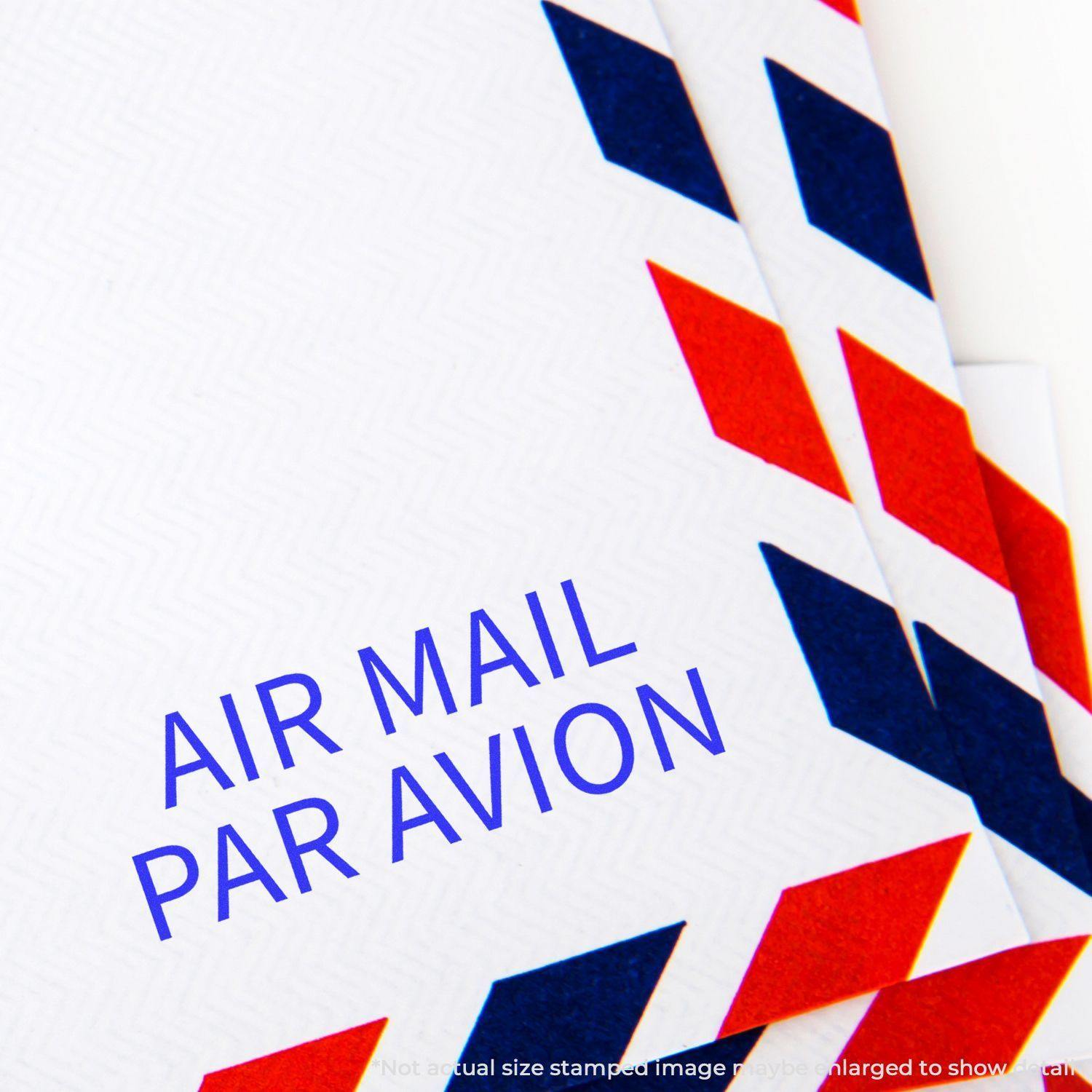 Close-up of an envelope stamped with the Large Pre-Inked Air Mail Par Avion Stamp, featuring red and blue chevron border design.