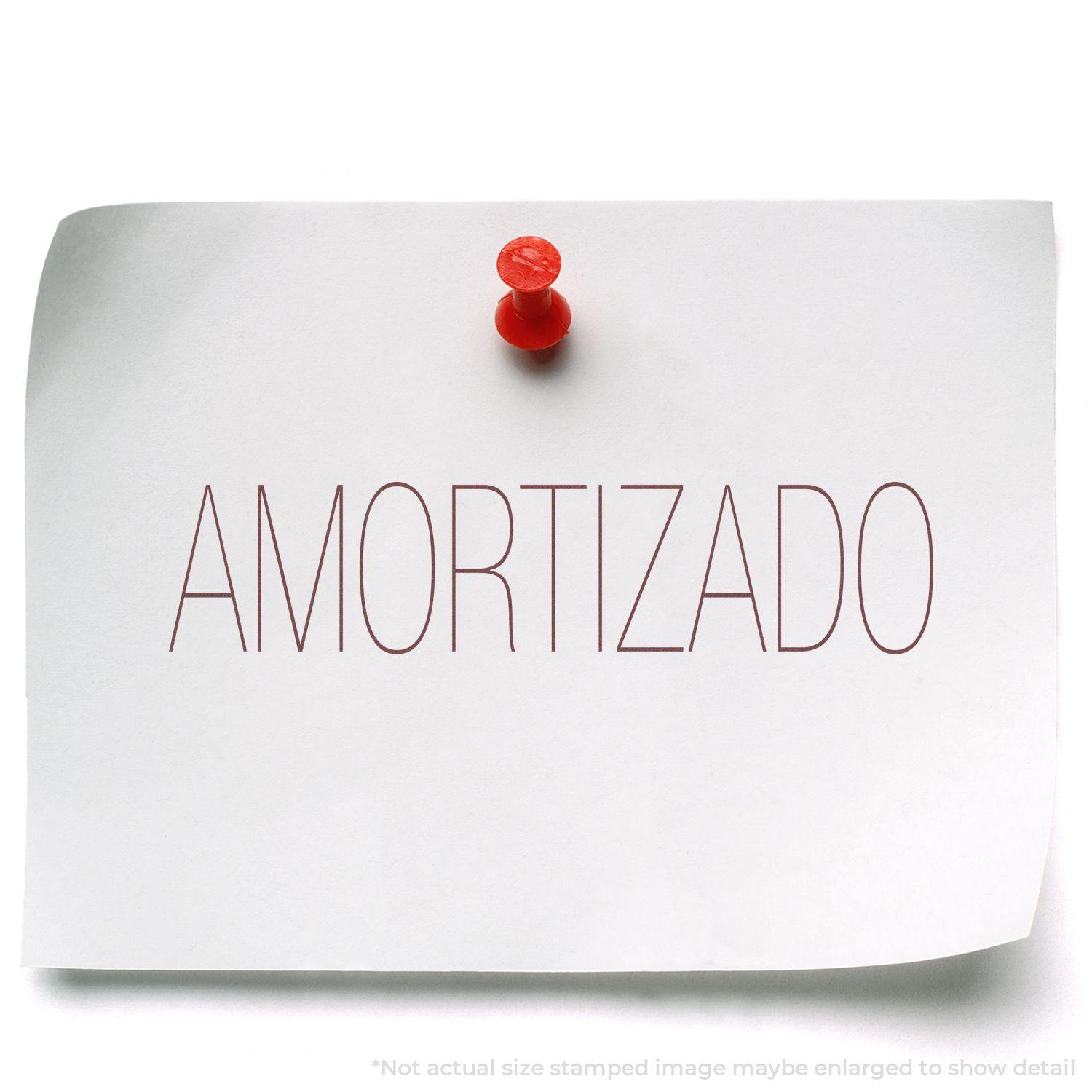 A white paper with "AMORTIZADO" stamped in red ink using the Amortizado Rubber Stamp, pinned to a surface with a red pushpin.