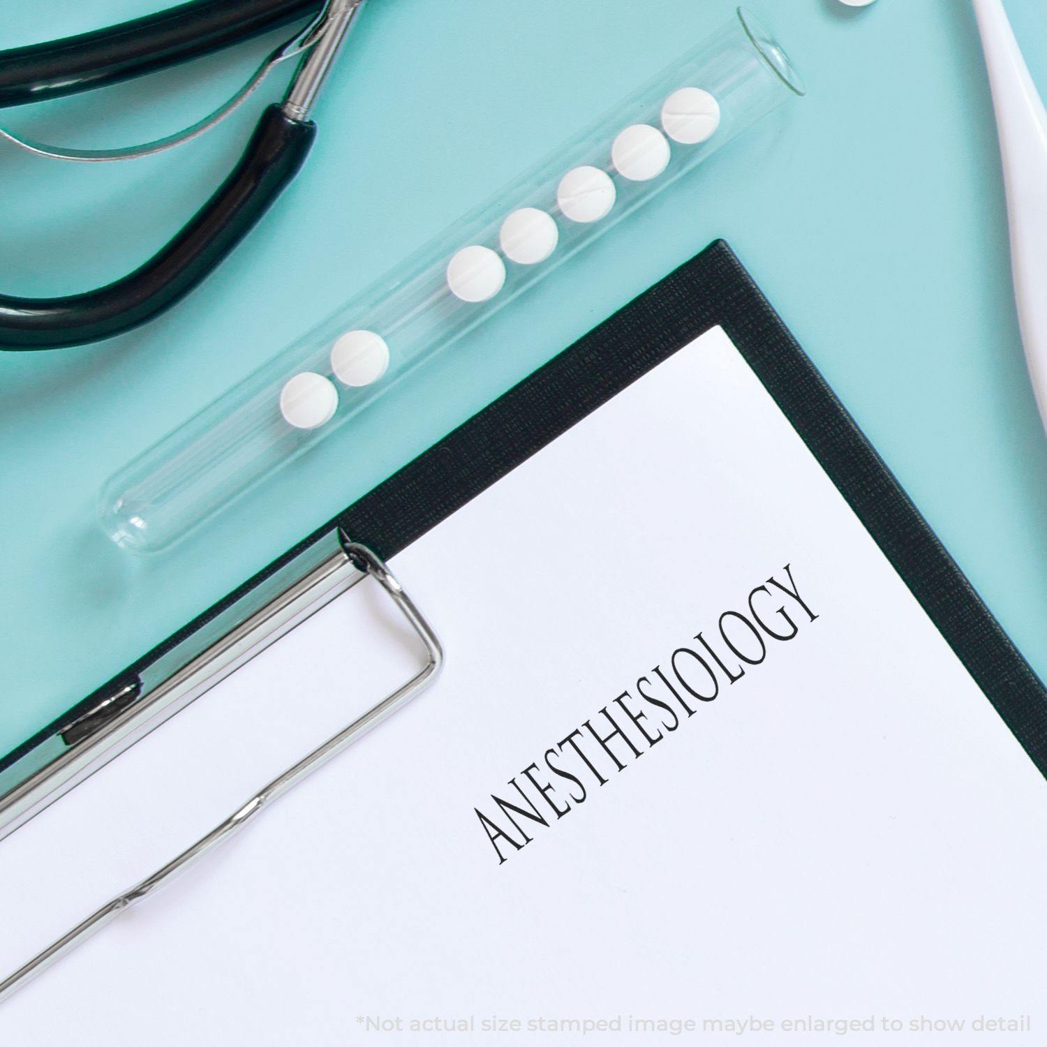 Anesthesiology rubber stamp on a clipboard with a stethoscope and a test tube of pills on a light blue background.