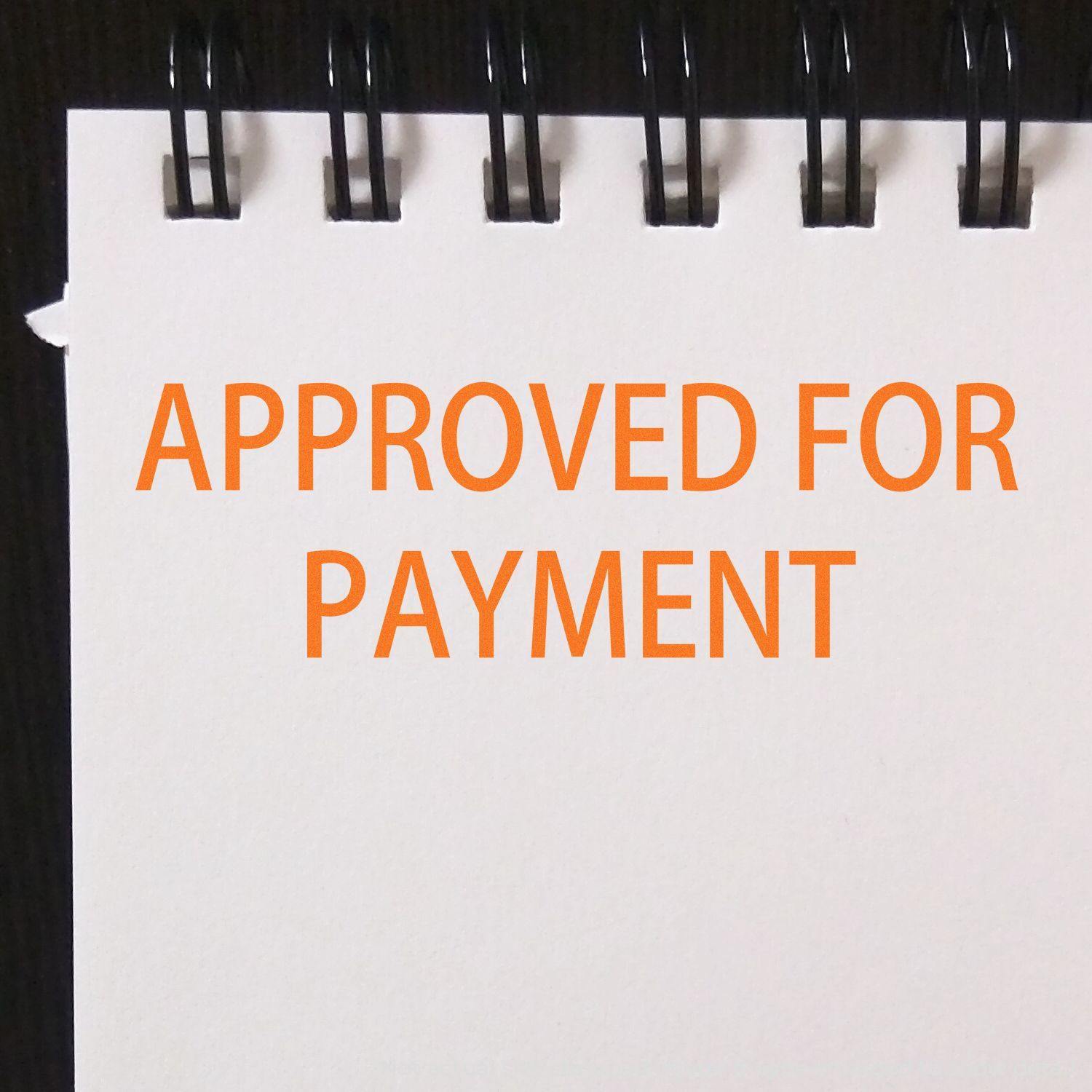 A notepad with APPROVED FOR PAYMENT stamped in orange using the Self Inking Approved For Payment Stamp.