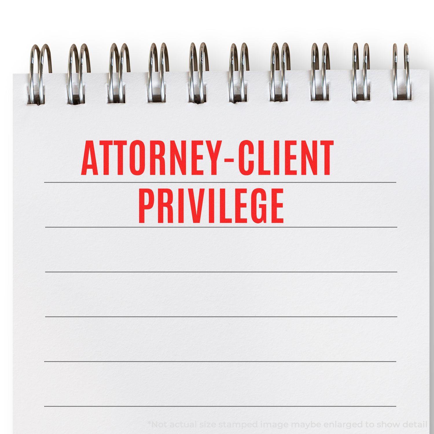 Attorney-Client Privilege rubber stamp impression on a spiral notebook with lined pages.