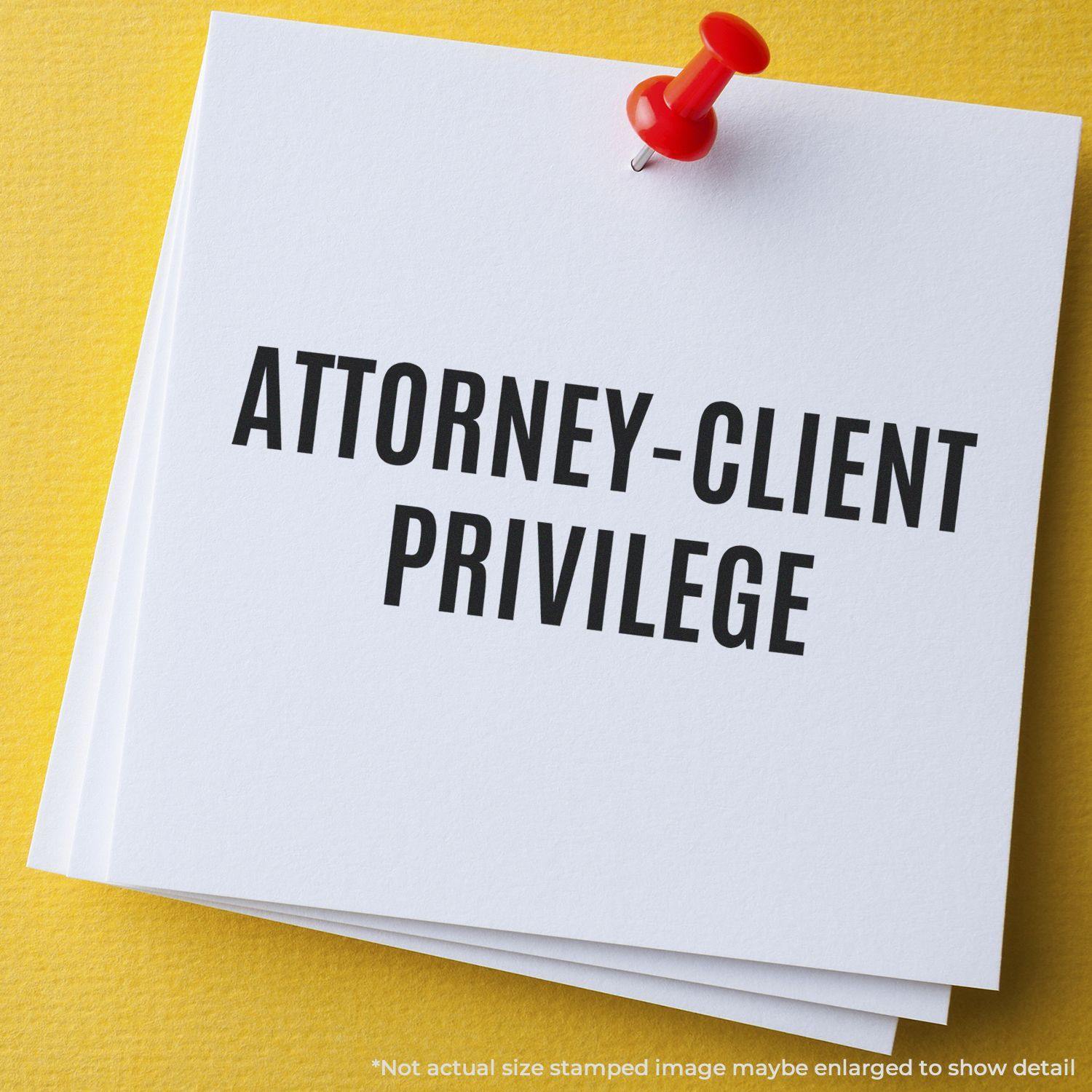 Attorney-Client Privilege rubber stamp on white paper pinned to a yellow board, emphasizing confidentiality in legal matters.