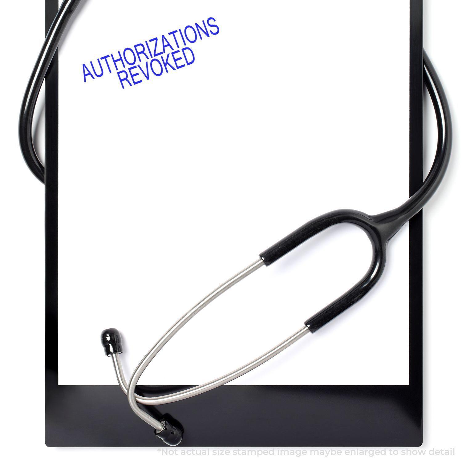 A stethoscope rests on a clipboard with a paper stamped AUTHORIZATIONS REVOKED using the Large Pre-Inked Authorizations Revoked Stamp.