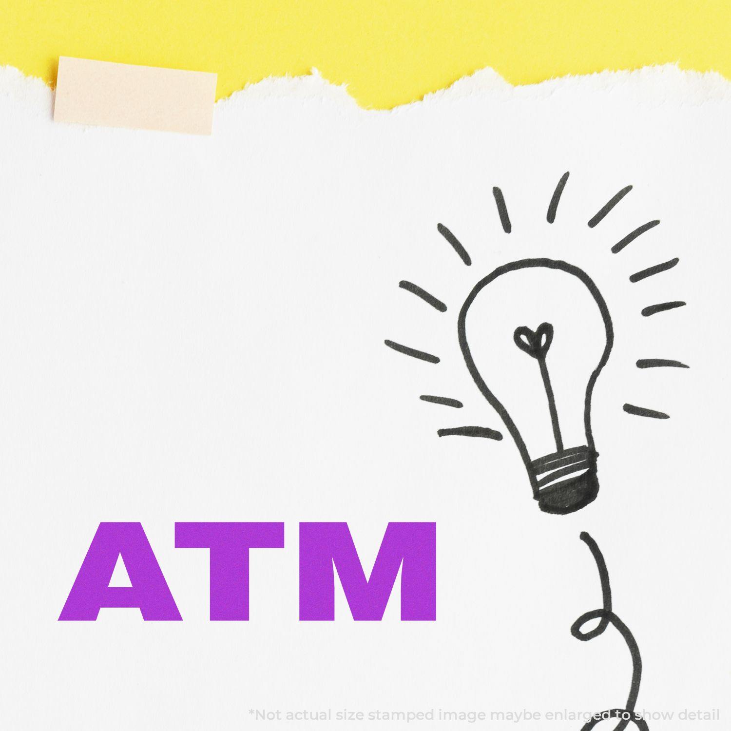 Large Self Inking ATM Stamp in use, showing a stamped ATM text in bold purple on a white paper with a lightbulb doodle.