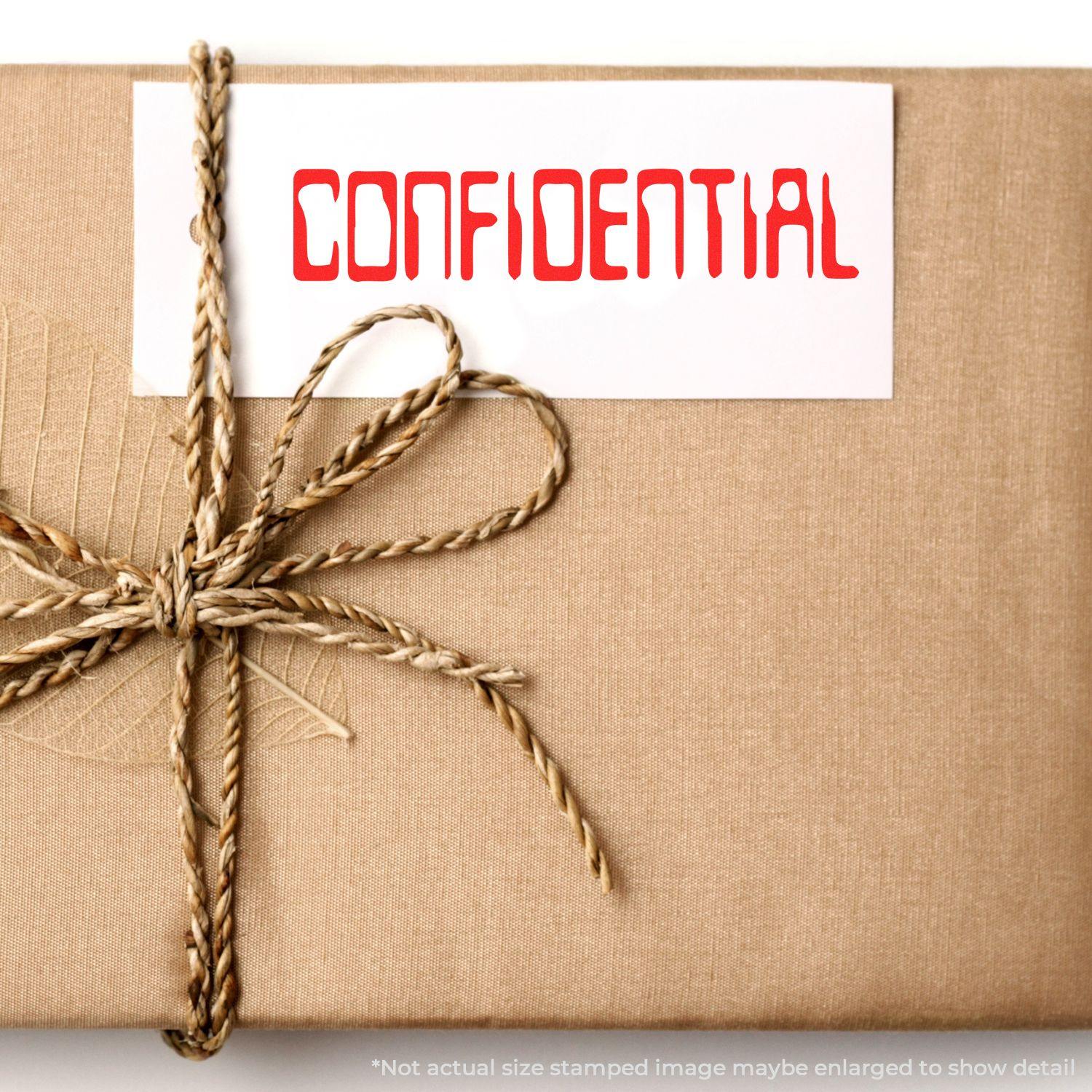 A brown package with a card stamped CONFIDENTIAL using the Large Self Inking Barcode Confidential Stamp, tied with a twine bow.