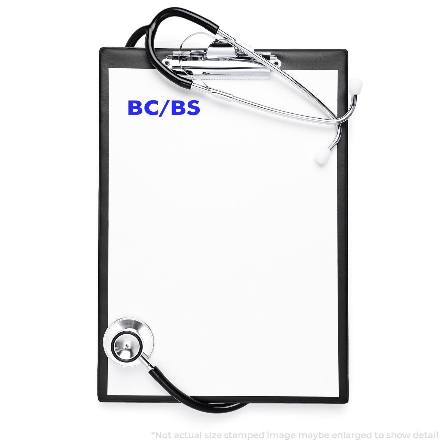 Clipboard with stethoscope and paper stamped with BC/BS using the Large BC/BS Rubber Stamp.