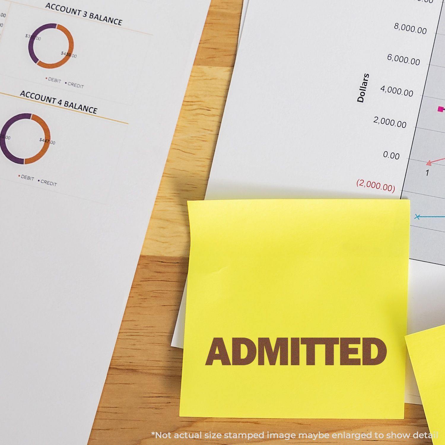 Slim Pre-Inked Bold Admitted Stamp used on a yellow sticky note, placed on financial documents with charts and graphs.